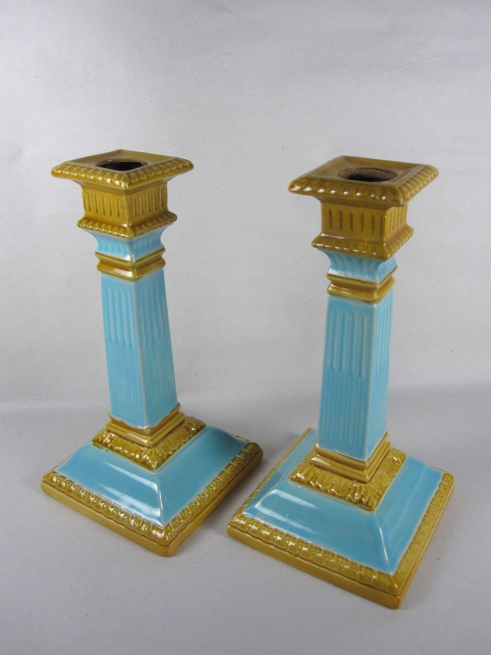 A scarce pair of Majolica glazed neoclassical column-form candlesticks made by William Brownfield & Son, Cobridge, Stoke-on-Trent, Staffordshire, England, circa 1892.

Brightly colored in turquoise blue and yellow ochre. Surprisingly fresh and