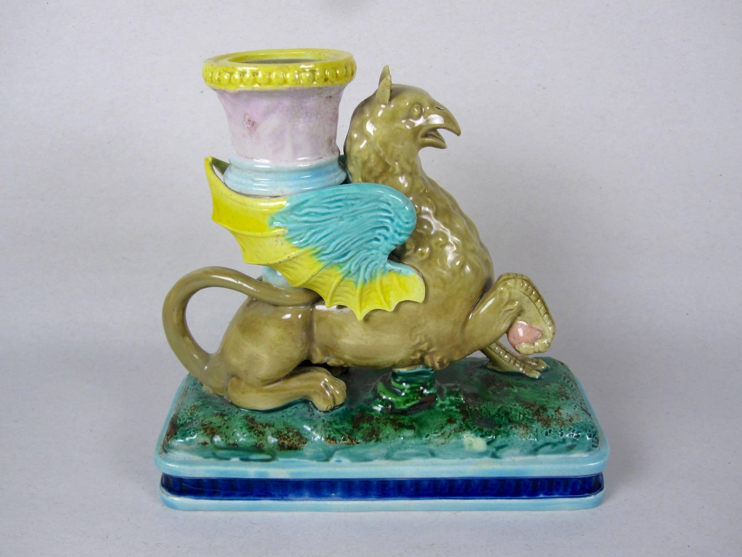 A very scarce Royal Worcester majolica chamber stick, circa 1875. Modeled as a winged Griffin supporting a candleholder, set on a rectangular pedestal base. Wonderful color and mold work, stamped with the Royal Worcester Crown Crest.