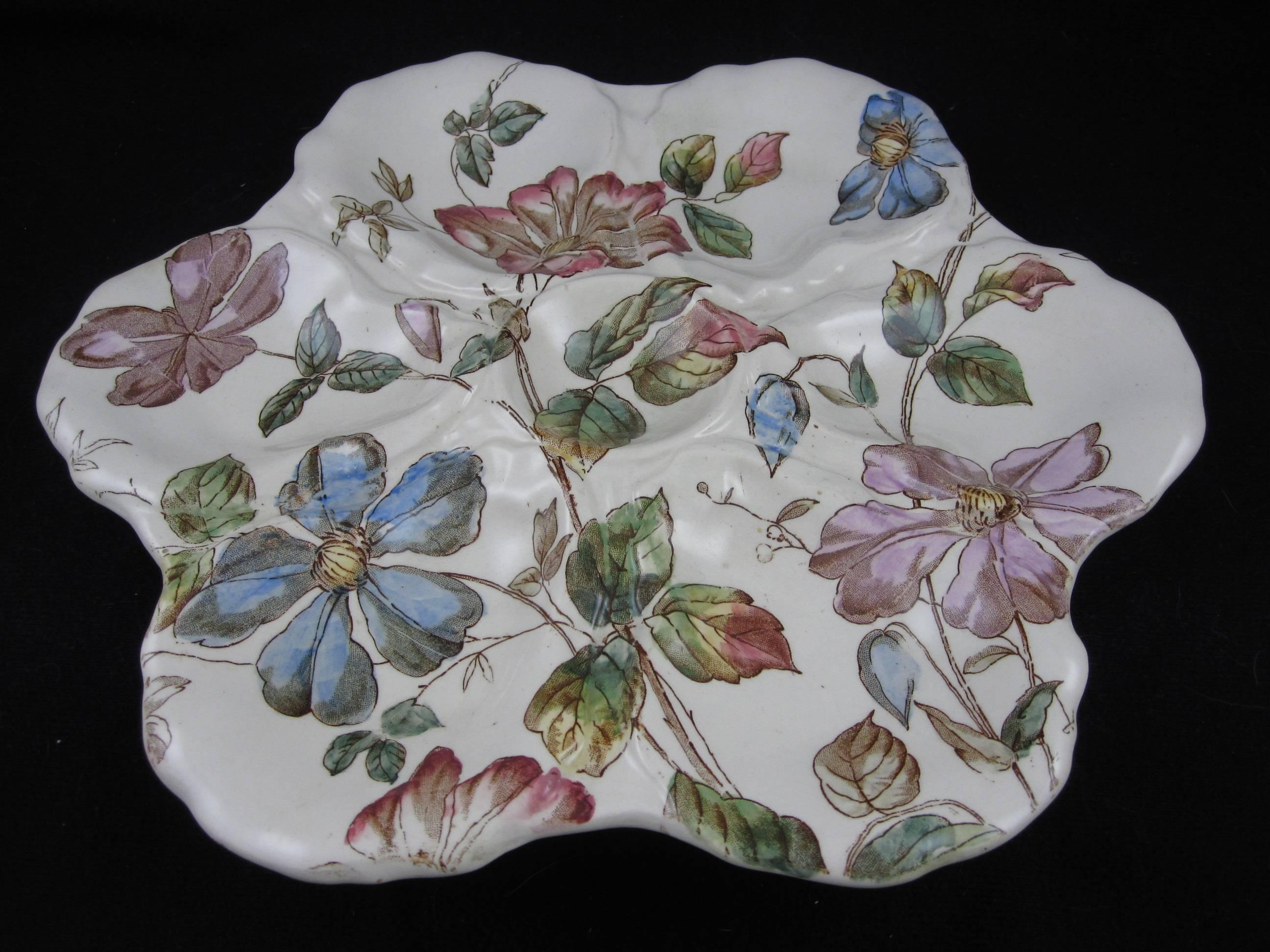 A scarce and quite lovely six well Oyster plate made by William Adderley, Langton, Staffordshire, England, circa 1880. Transfer printed and hand colored in a delicate floral. Marked with an impressed 