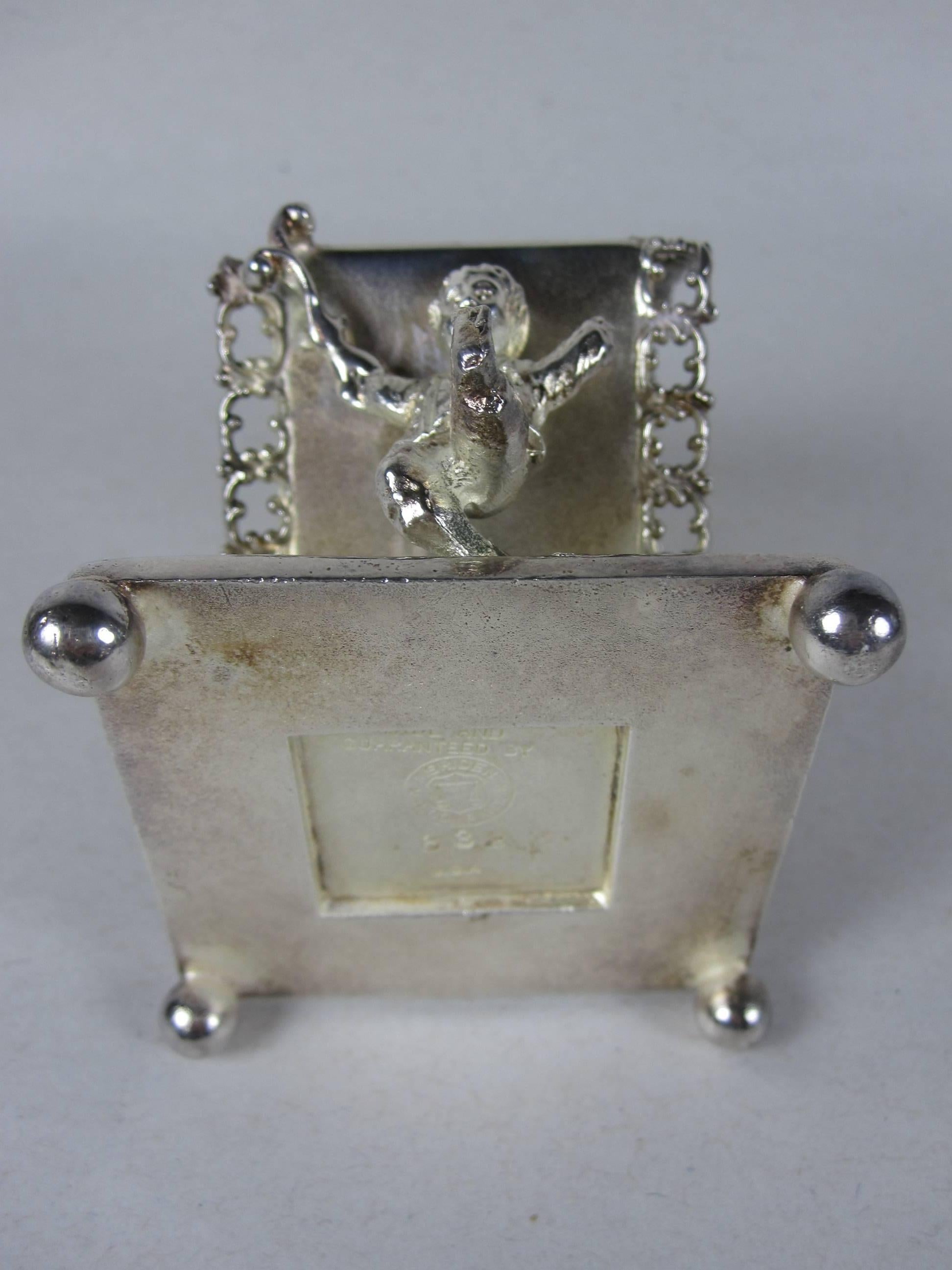 Antique Victorian Scrolled Silver Plate Boy Carrying a Standing Napkin Ring 1