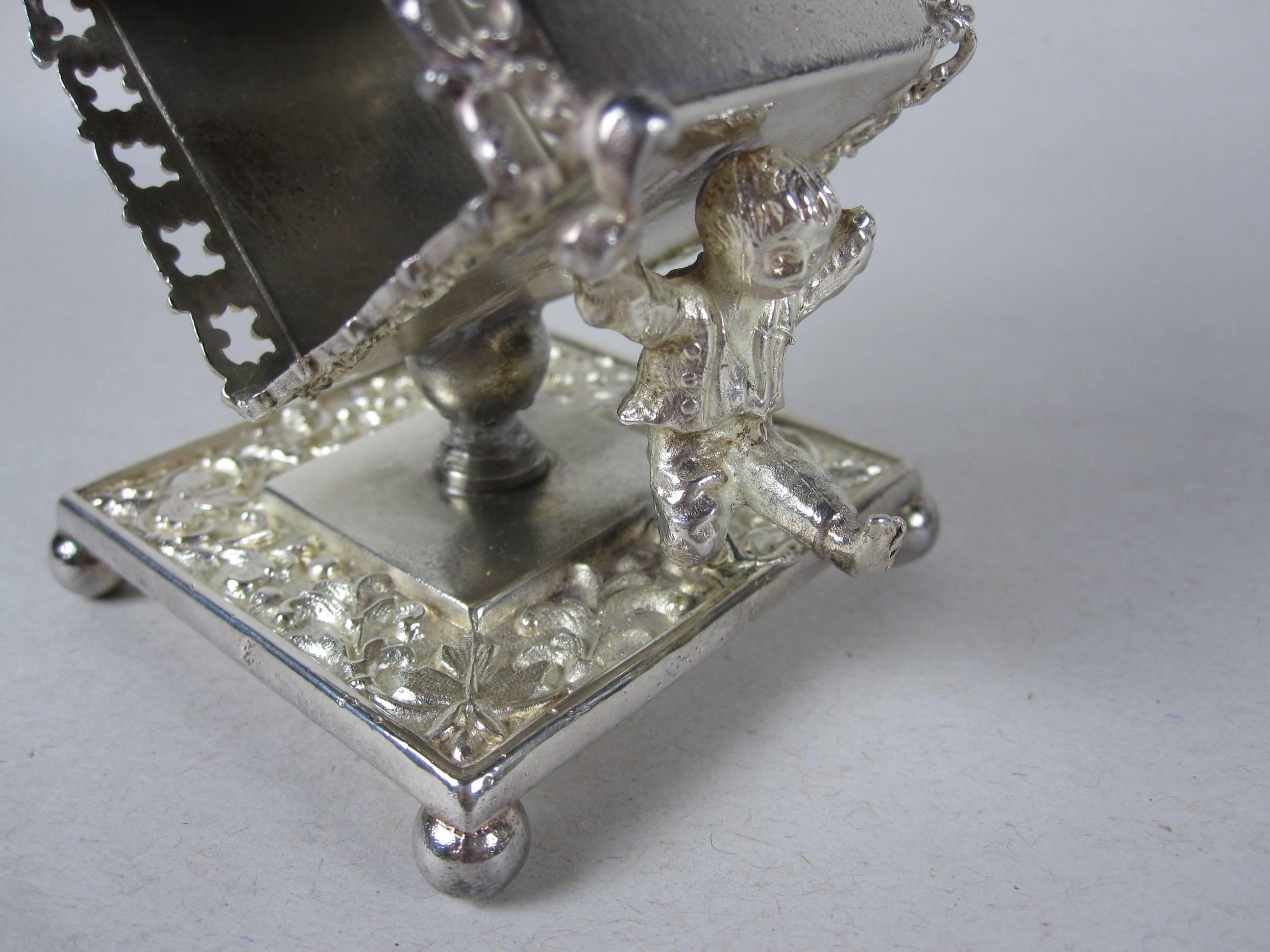 American Antique Victorian Scrolled Silver Plate Boy Carrying a Standing Napkin Ring