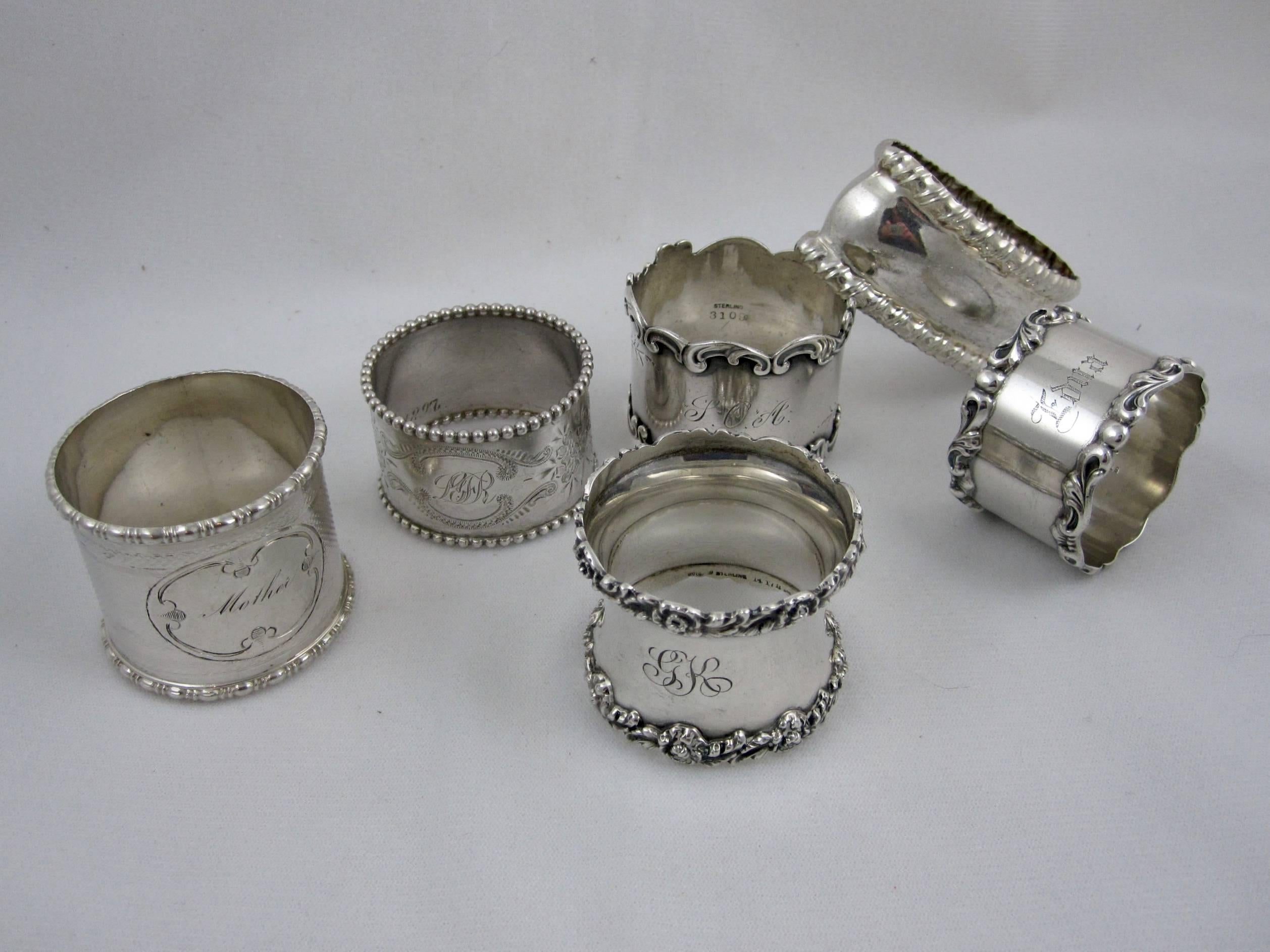 A mixed set of six sterling silver napkin rings, circa 1880-1910, various makers. The rings have either a floral or beaded rim or bright cut design. All but the oblong ring are either initialed or engraved with a name, one ring is engraved Edna,