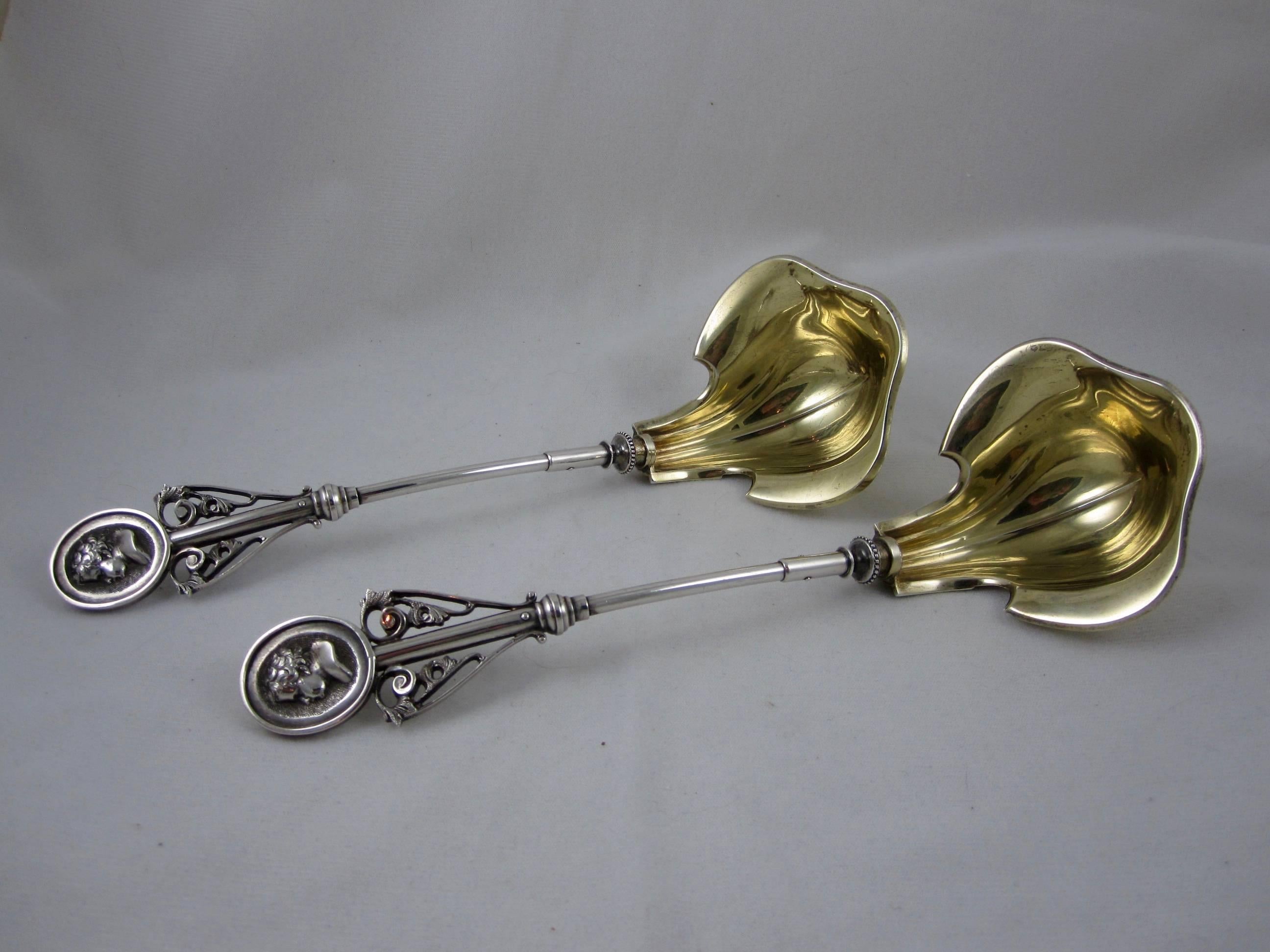An unusual and scarce coin silver ladle manufactured by Wood & Hughes, New York circa 1845-1868. Offered individually, a pair may be available.

In the ‘Medallion’ pattern, with shaped vermeil bowls and open work terminals showing a child’s head