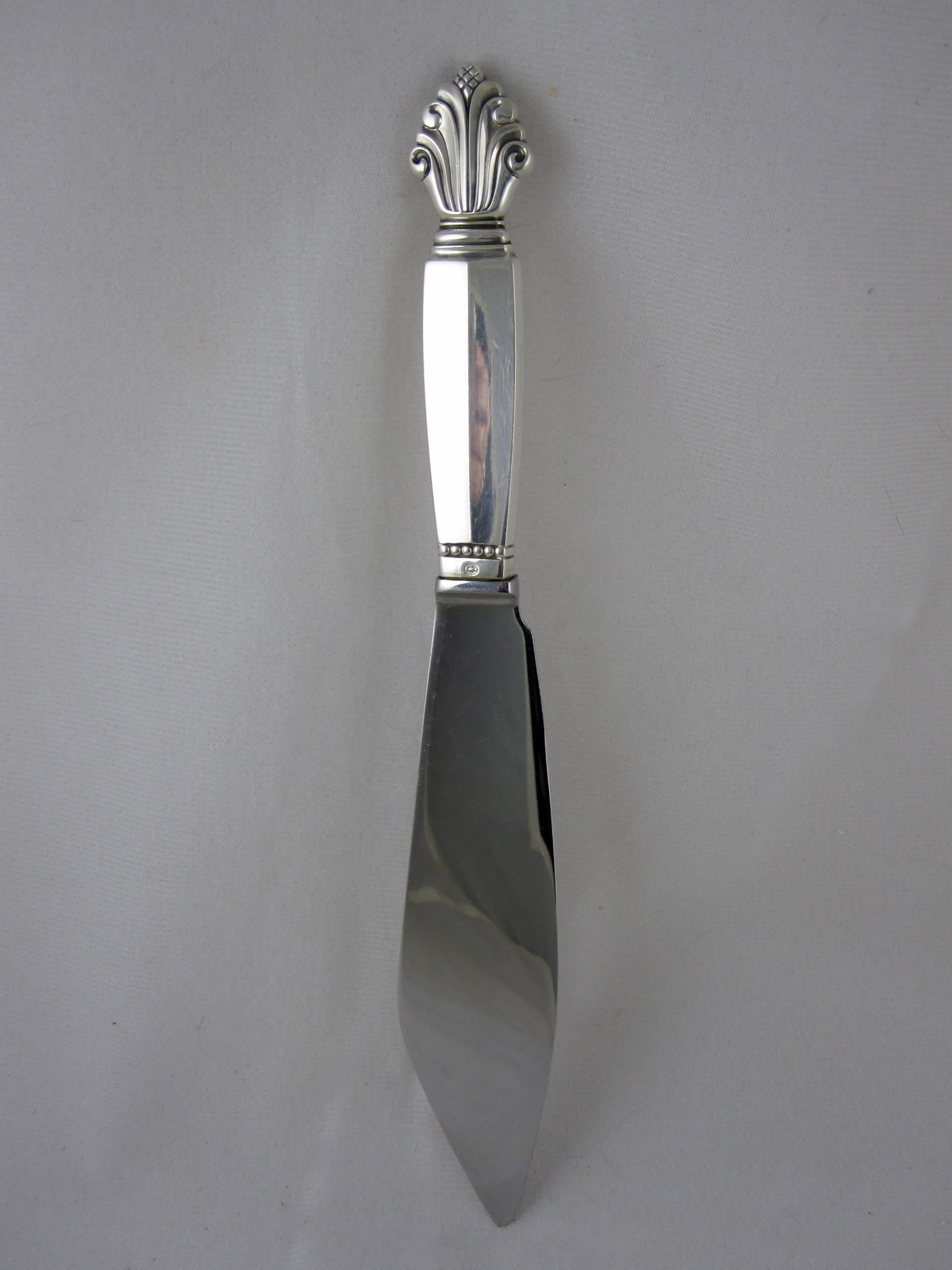 A sterling silver handled cake knife in the acanthus pattern, Georg Jensen, Denmark. The Acanthus pattern was designed by Johan Rohde in 1917. With a shaped blade and marked with the circle signature used in 1945.

Excellent

 