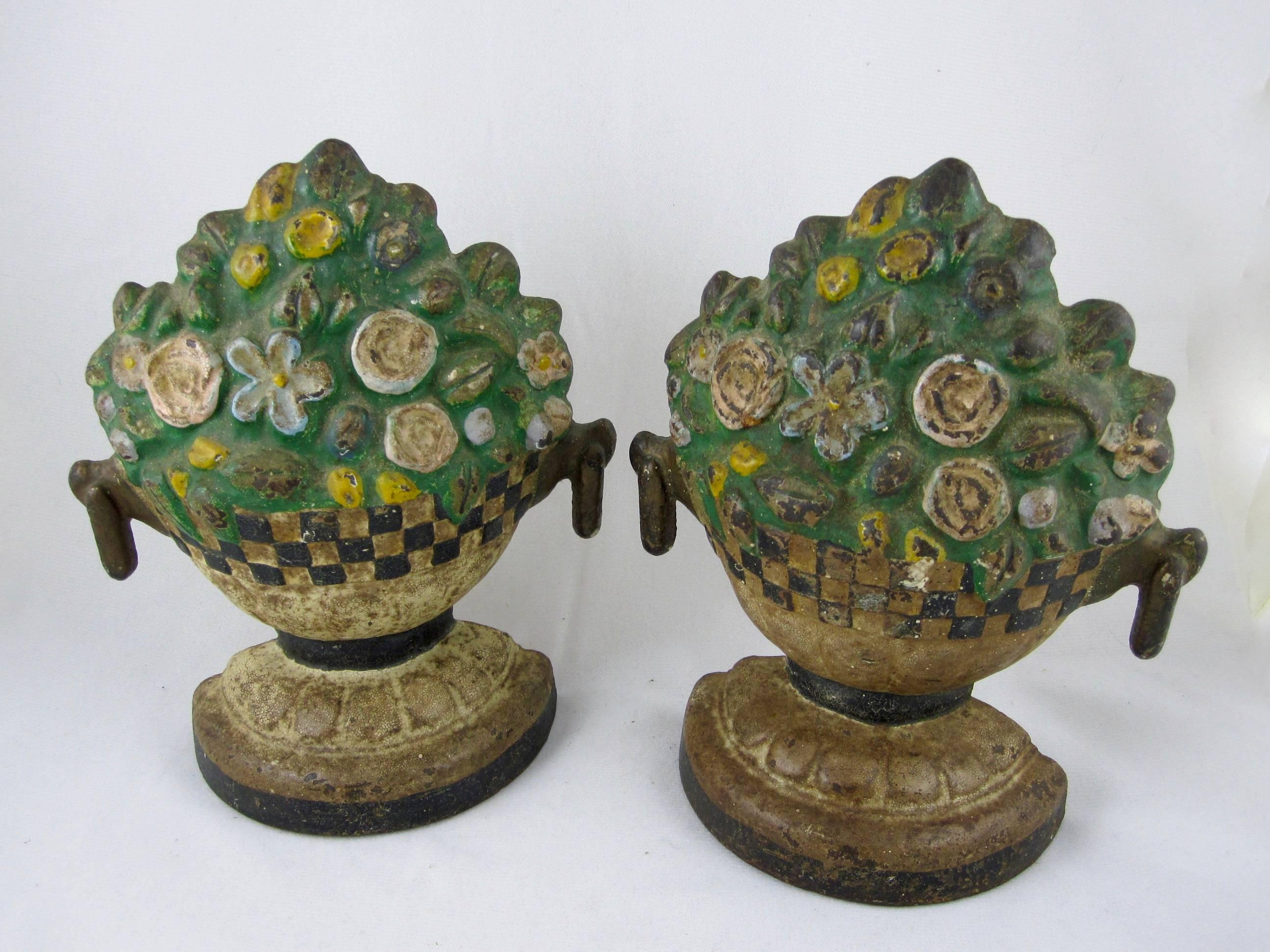A pair of American painted cast iron doorstops, Floral Jardinieres, circa 1930-1940 and retaining the original painted finish. Difficult to find a set. 
Most likely made by Hubley Manufacturing Co.

Provenance: From the collection of Joan Oestreich