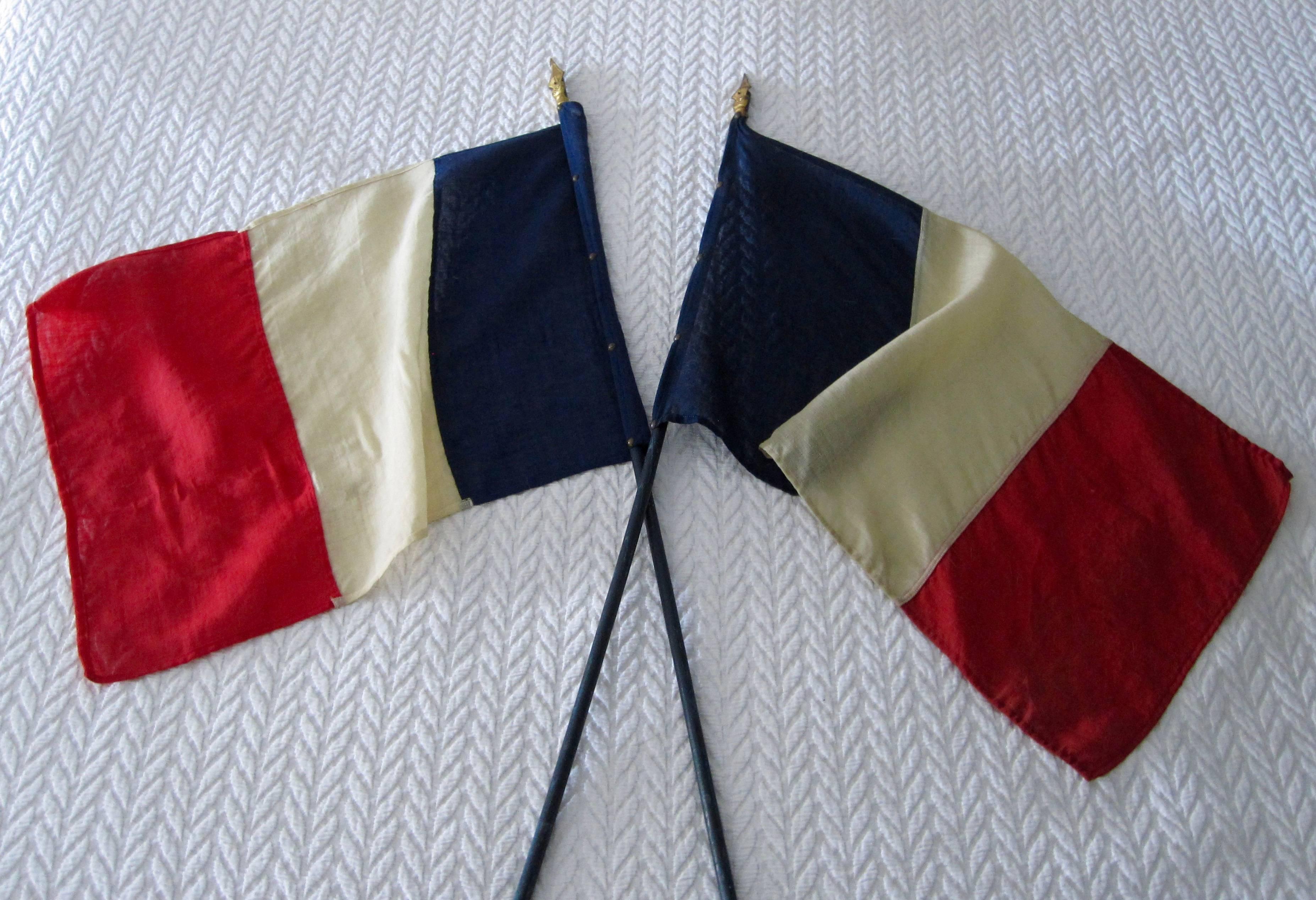 A pair of 1940s French tri-color flags dating to the end of the 2nd World War.
After the liberation of Paris and the end of WWII was declared, French citizens were given these large processional flags to celebrate with the allies and the returning
