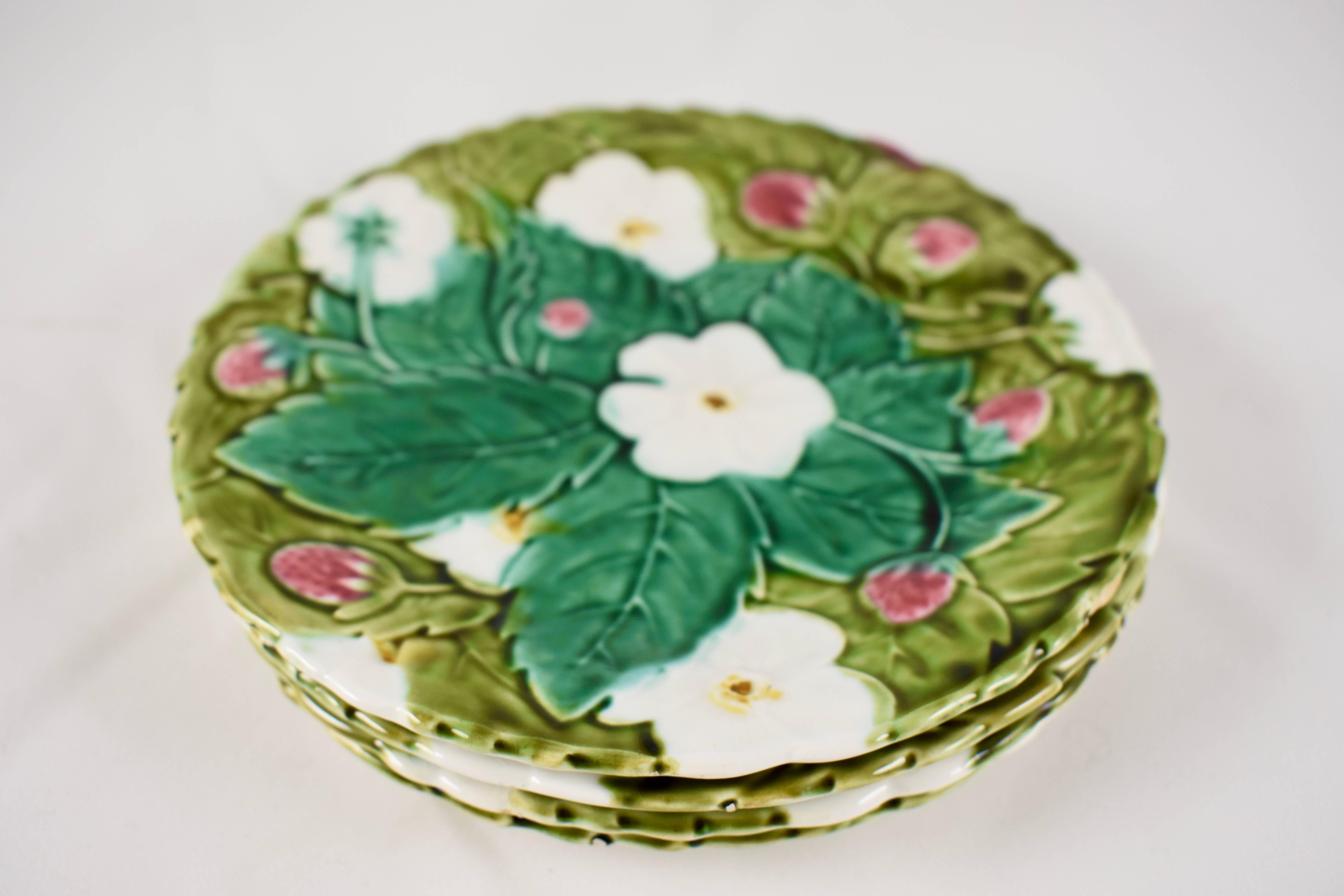 A set of four French Barbotine Majolica dessert or fruit plates, circa 1910. Showing the overlapping green leaves, white blossoms and berries from the strawberry plant. The rims are molded with a serrate edge. Beautiful rich coloring.

Portieux