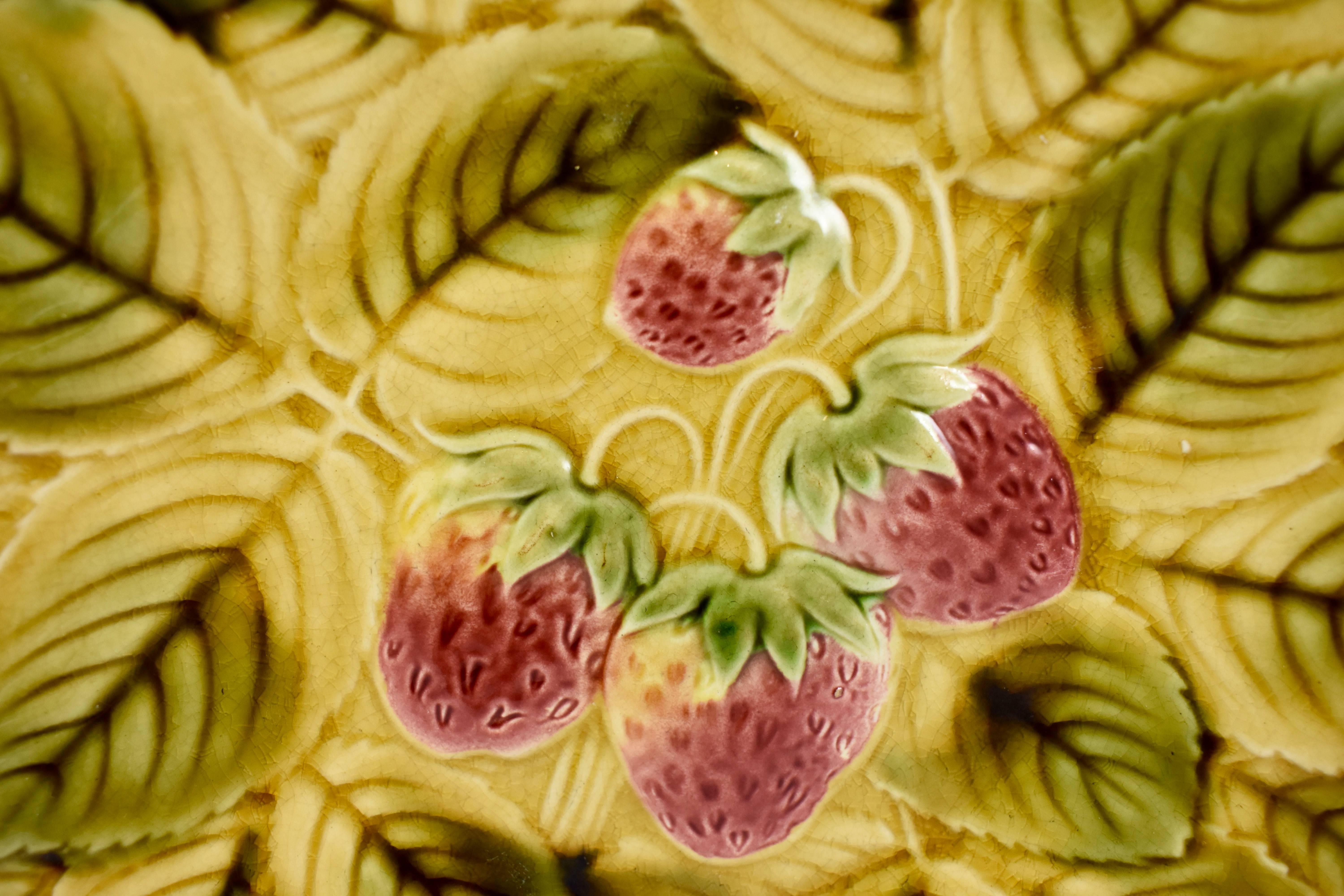 A Sarreguemines French faïence, Majolica round serving tray, showing four strawberries on a ground of overlapping leaves. The shaped rim follows the leaf form. Glazed by hand, beautiful coloring.

Showing both impressed and printed marks: