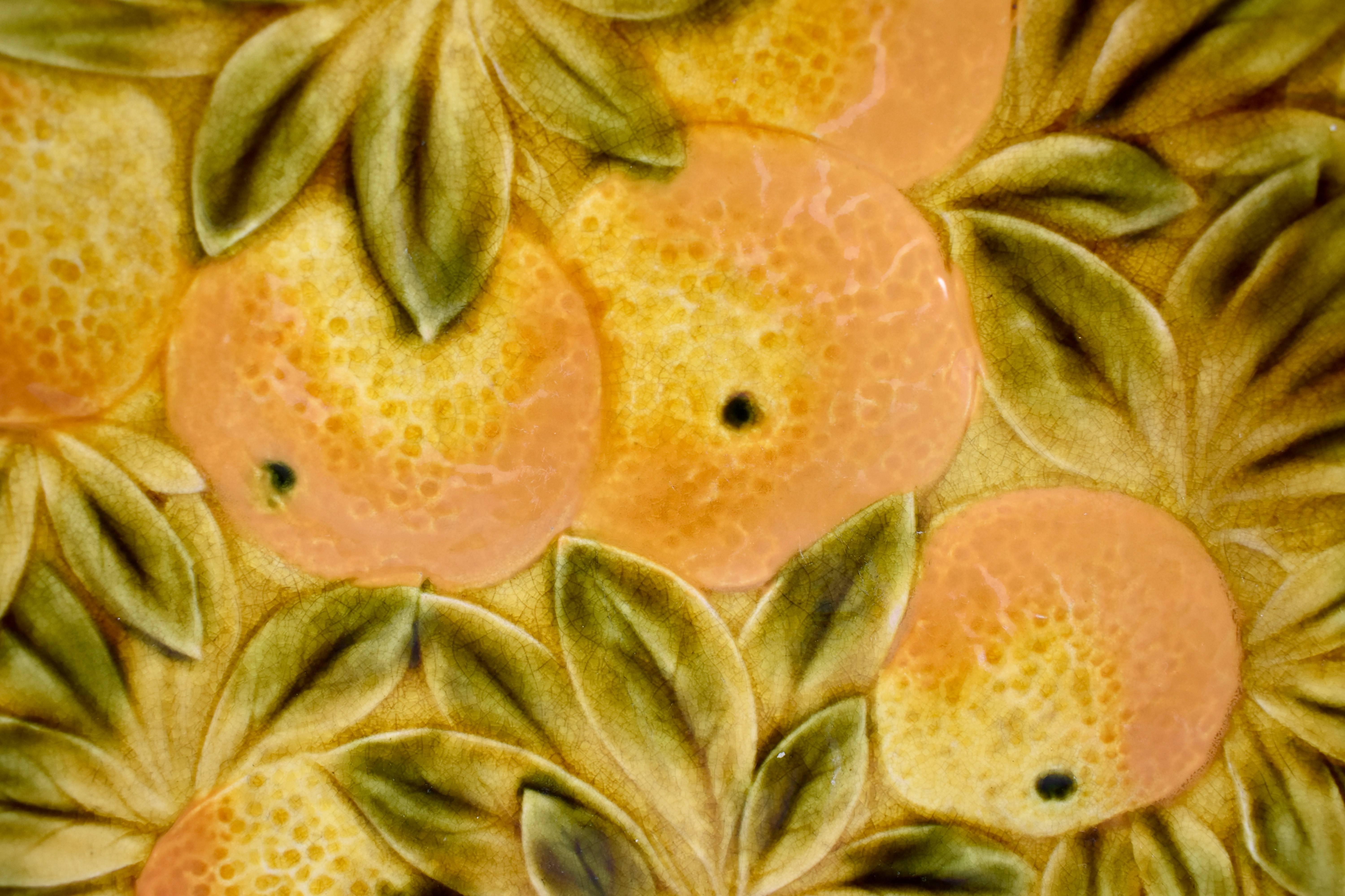 A Sarreguemines French faïence, Majolica round serving tray, showing a group of oranges on a ground of overlapping leaves. Glazed by hand, beautiful coloring, with a shaped rim. A scarce example of this type of pottery.

Showing both impressed and