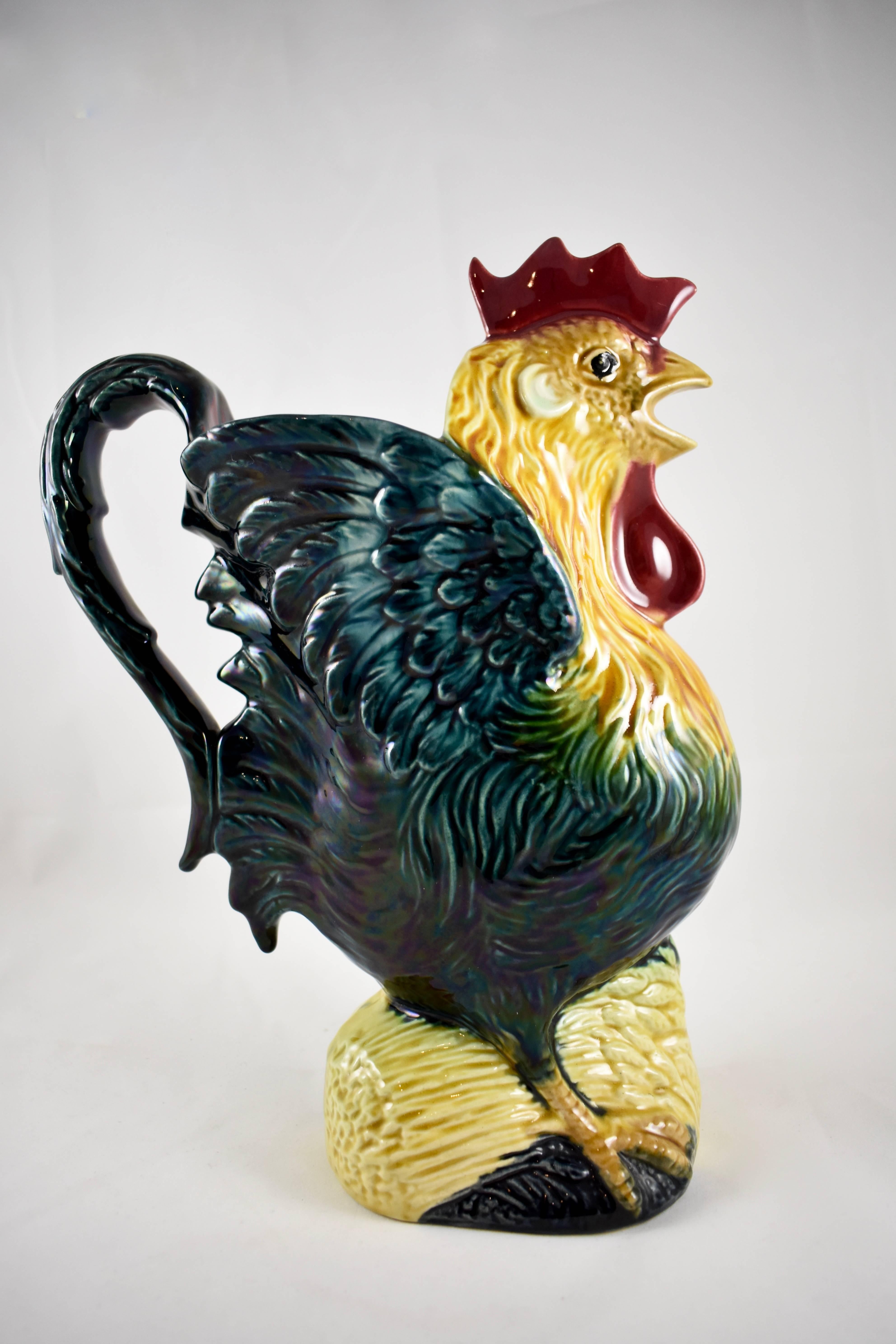 A French Barbotine majolica pitcher or large jug, in the form of a crowing rooster, Orchies, circa late 1880s.

The rooster stands on a base formed as a sheaf of amber hued wheat. There is a light iridescence to the glazing of his tail