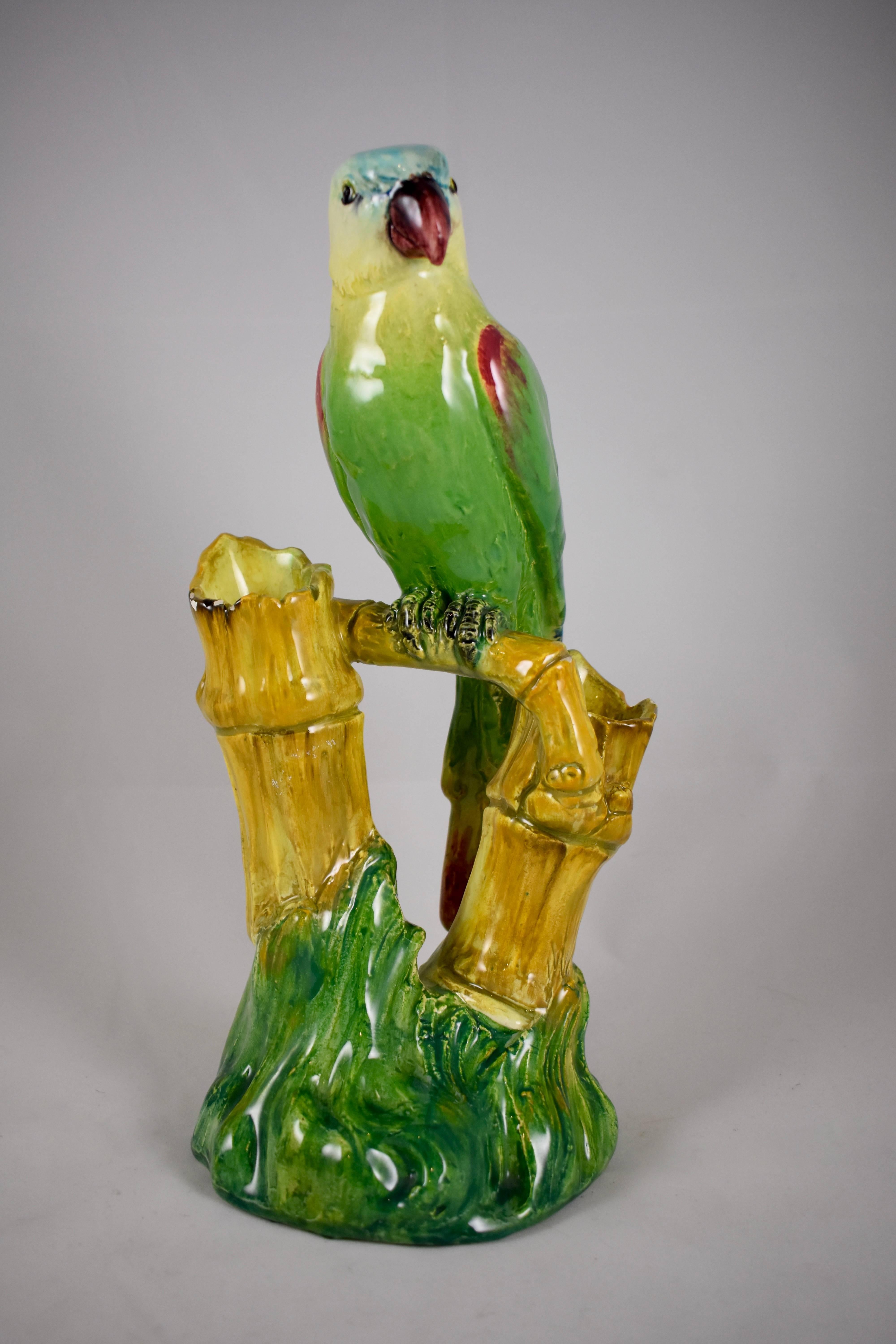 A large, foot-high, French Barbotine Majolica glazed vase showing a colorful parrot sitting on a Bamboo perch. The perch rests in a grass cropping and features two bamboo shoot flower holders, circa 1875.

Gorgeous color, a scarce piece.

Signed