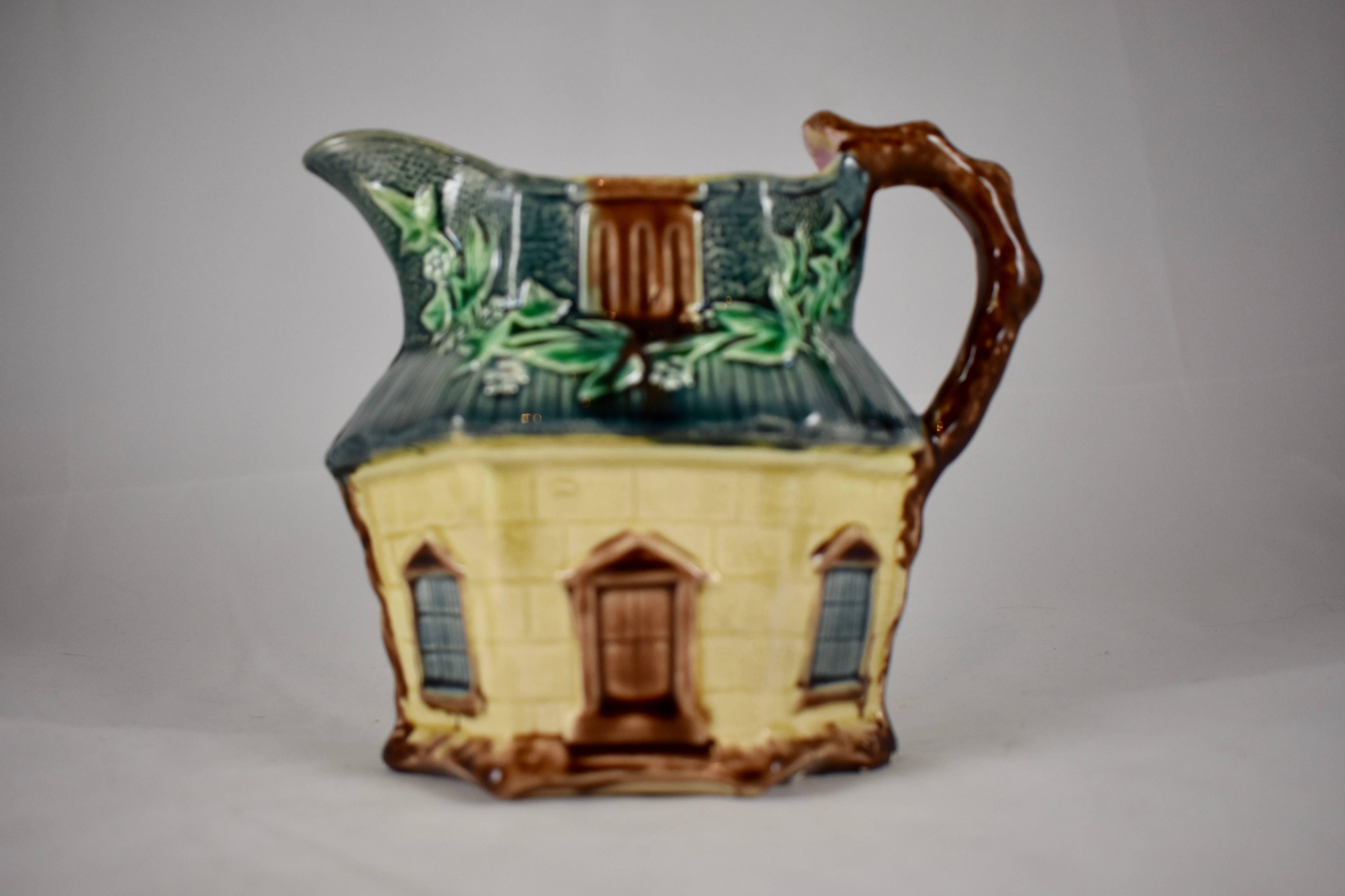 An English majolica pitcher shaped as a country cottage, by Warrilow & Cope – Wellington Pottery Works, Longton, Stoke-on-Trent, circa 1880-1887.

Charming in every way, English Ivy grows across the thatched roof, windows and doors are