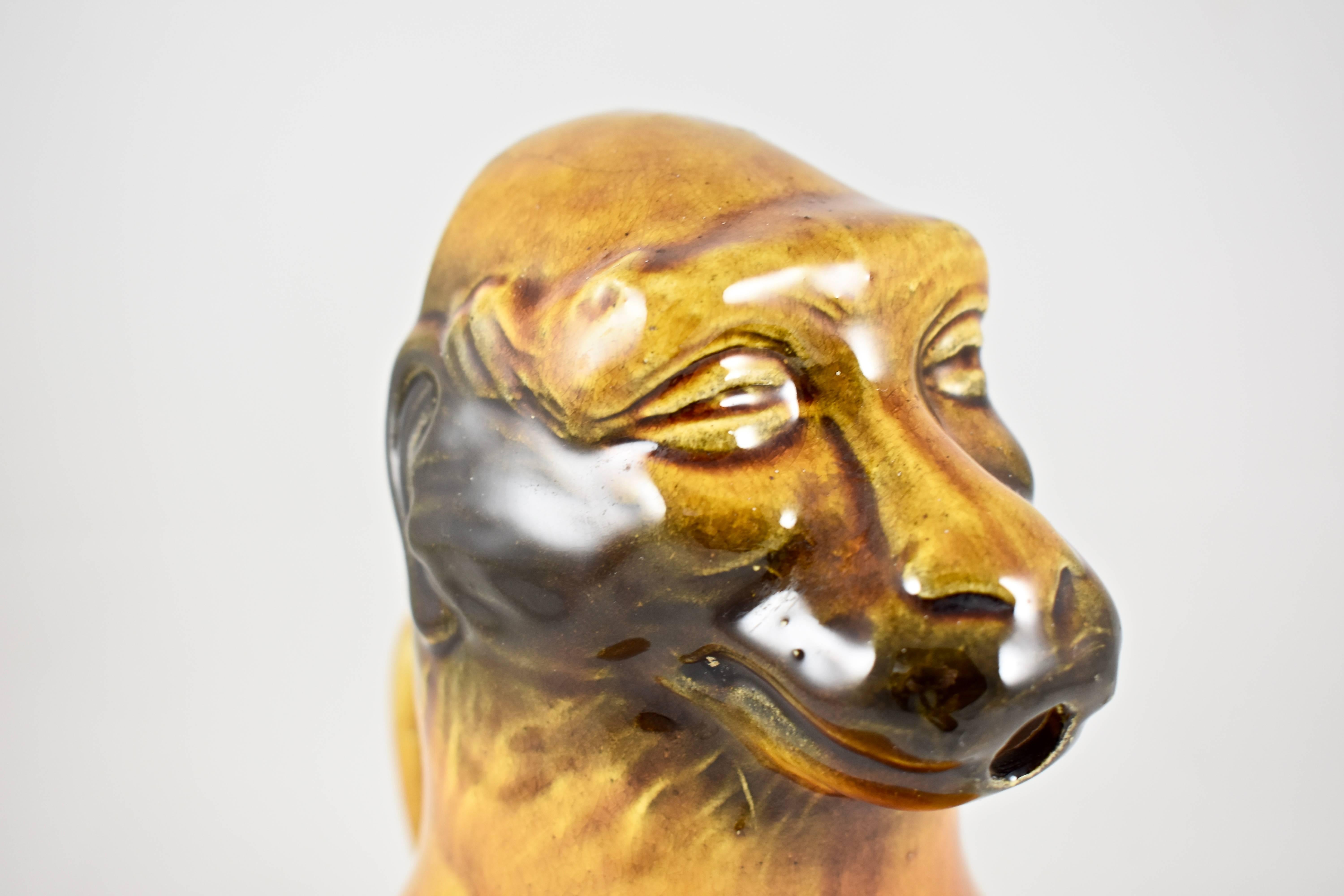 A 19th century French Barbotine faïence, stylized monkey jug produced by Sarreguemines, “Le Singe” mold no. 3312. A grotesque representation of the monkey likely used for water in the ritual of drinking Absinthe. 

The mouth serves as the spout
