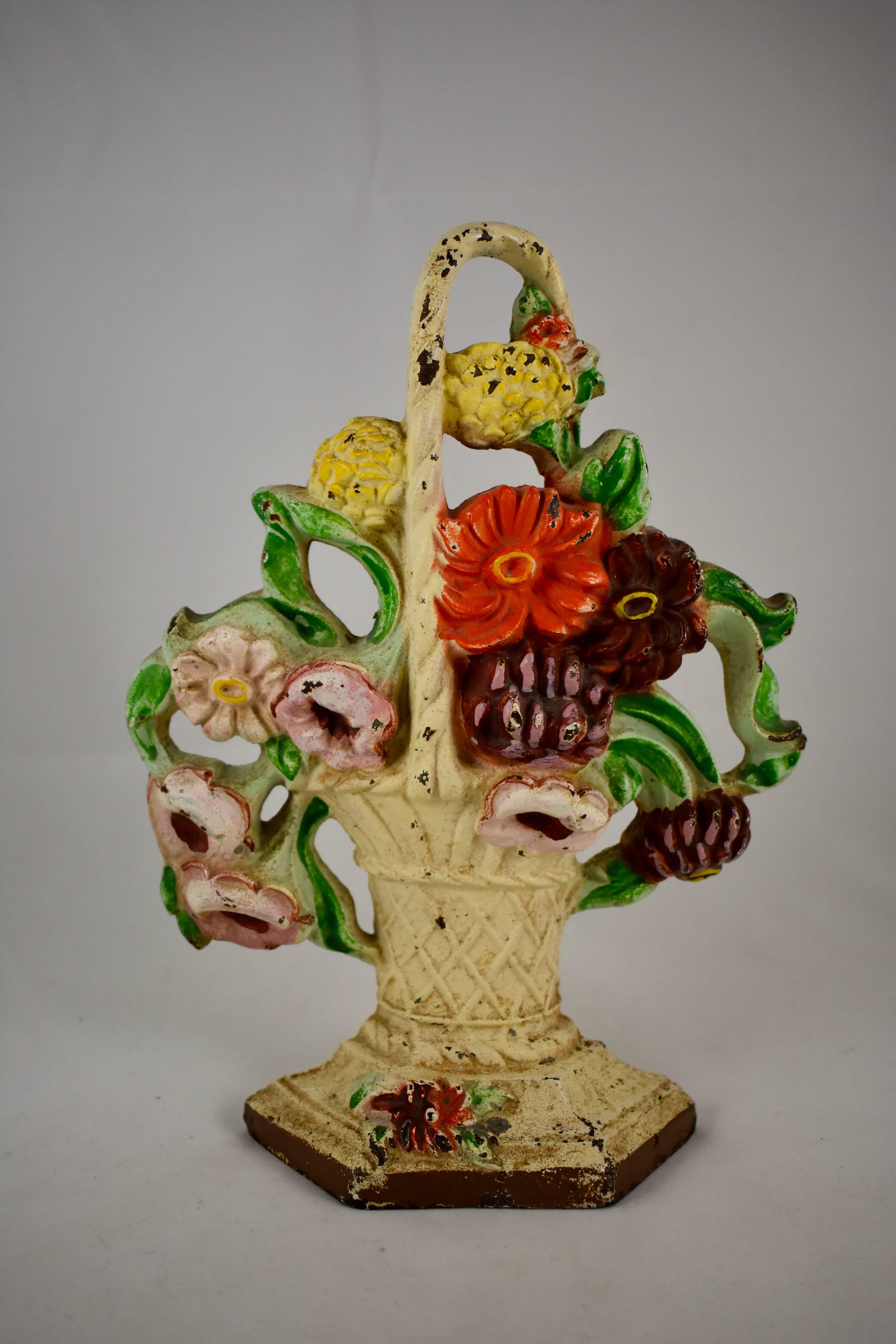 A vintage Hubley cast iron doorstop showing a bouquet of pink petunias and boldly colored straw flowers, held by a white, handled wicker basket. Retaining the original painted finish,

circa 1930.

The Hubley Manufacturing Company was first