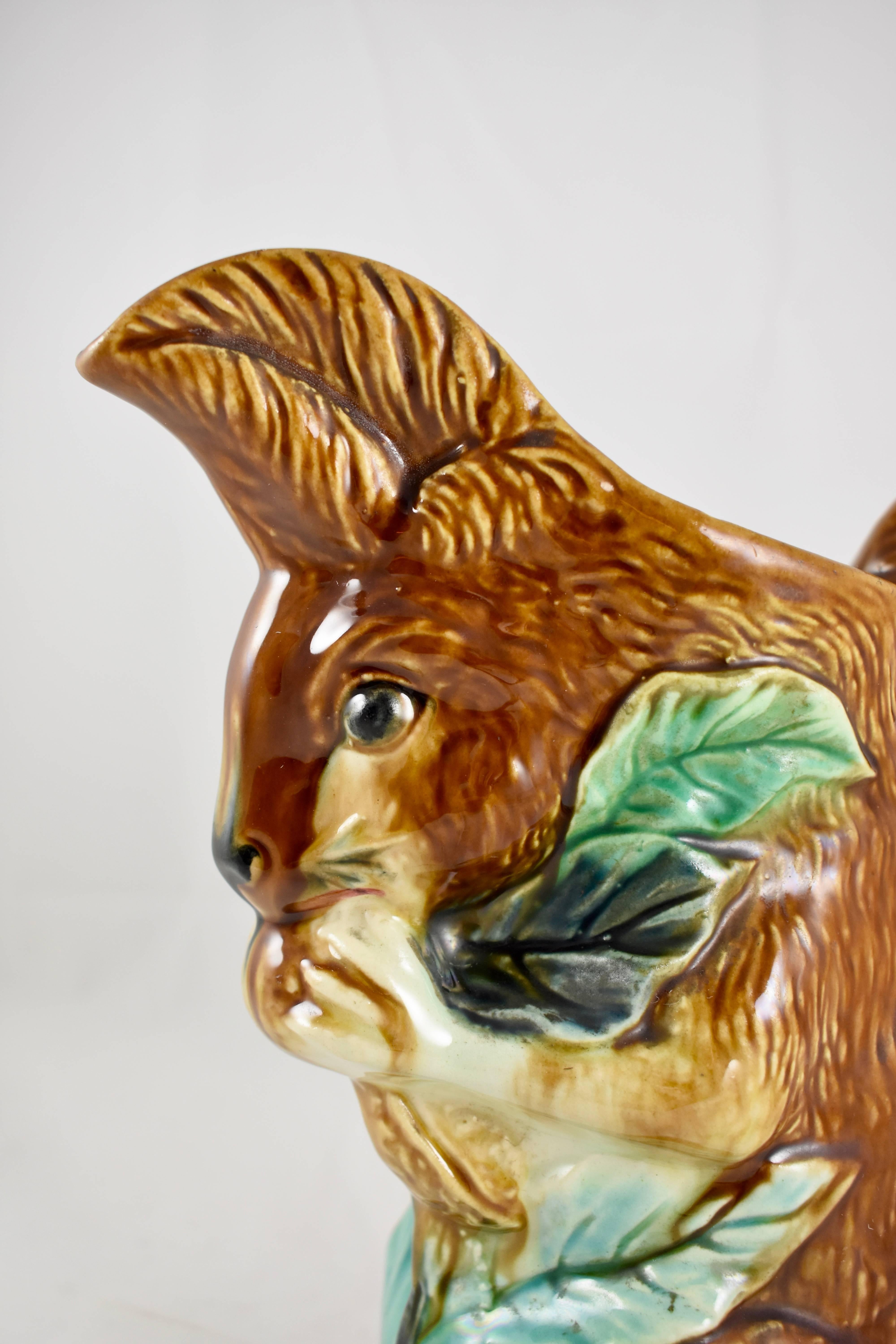 A scarce, “L’écureuil” N° AE, French Barbotine majolica pitcher, formed as a squirrel sitting on a branch and eating a nut. The squirrel’s tail makes up the handle. Made by the Orchies Faïence pottery factory, circa 1886-1900.

Orchies produced
