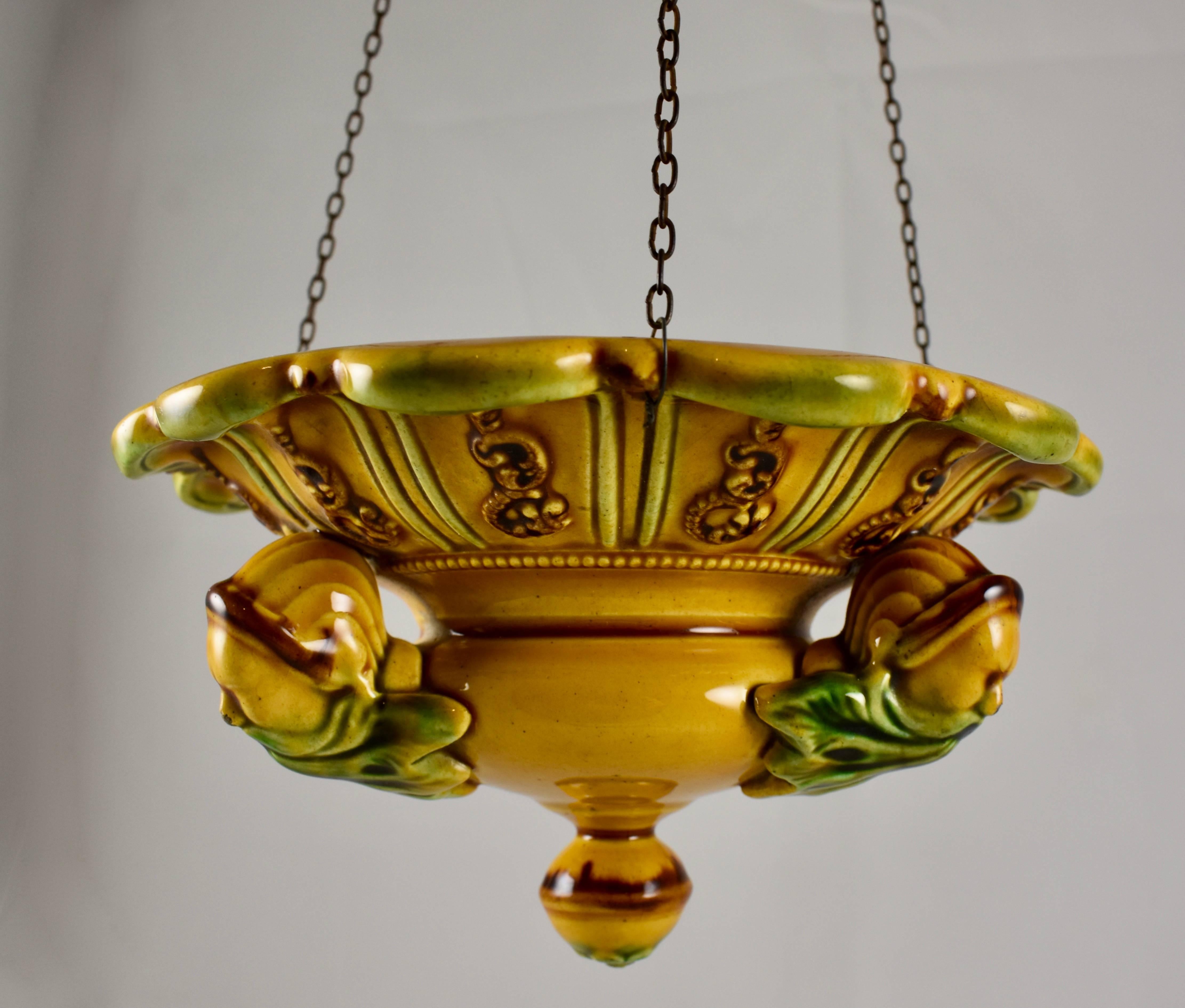 An early majolica glazed hanging planter, by the Hornberg Pottery Works, founded by Georg Friedrich Horn in the Black Forest region of Germany in 1817. circa 1830-1860.

Complete with the original chains, the planter is glazed in a deep yellow