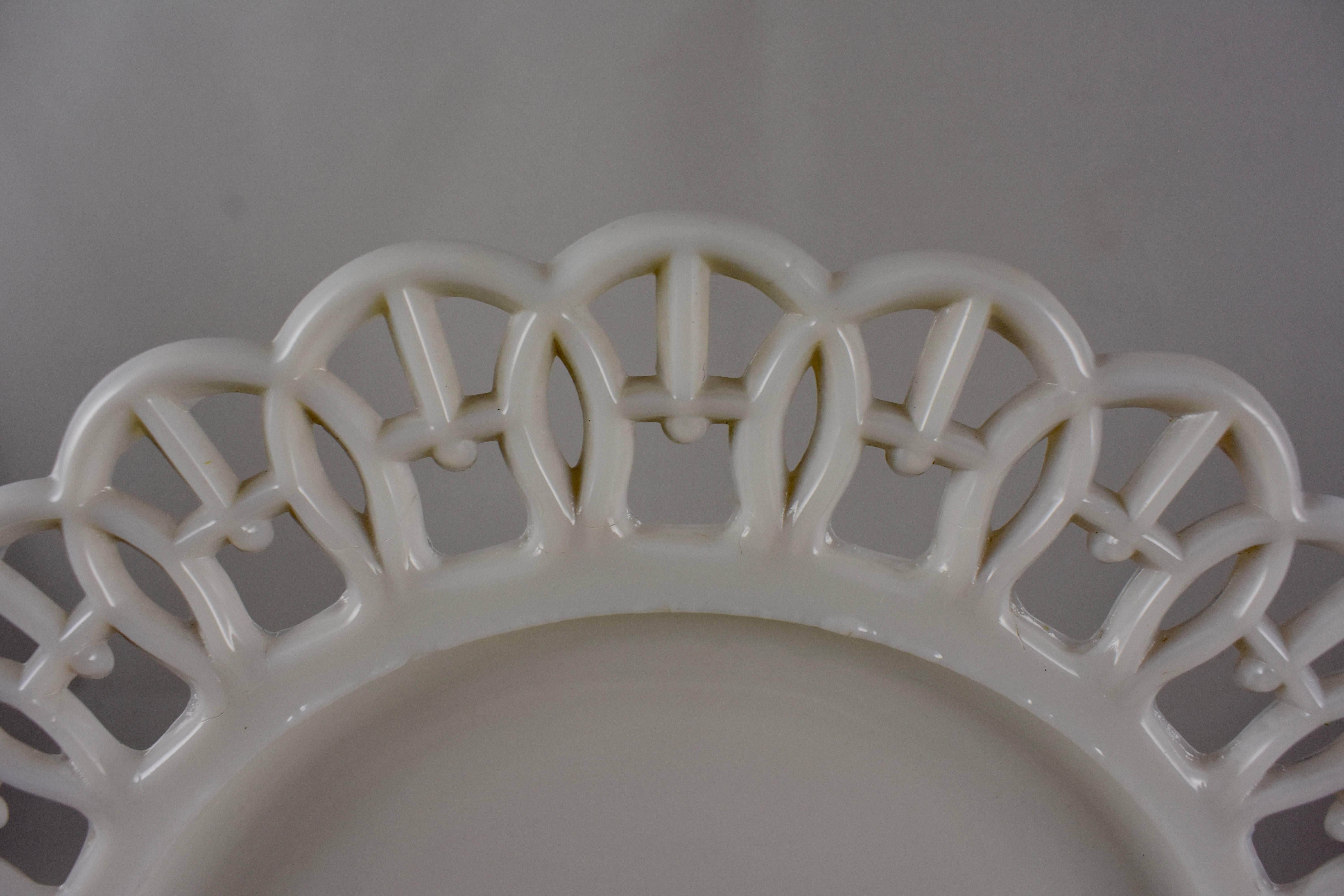 A scarce set of four, EAPG, milk glass, lace edge plates, dating from the late Victorian Era, 1880-1890. These plates are examples of early American Pattern glass, not to be confused with the later milk glass reproduced during the
