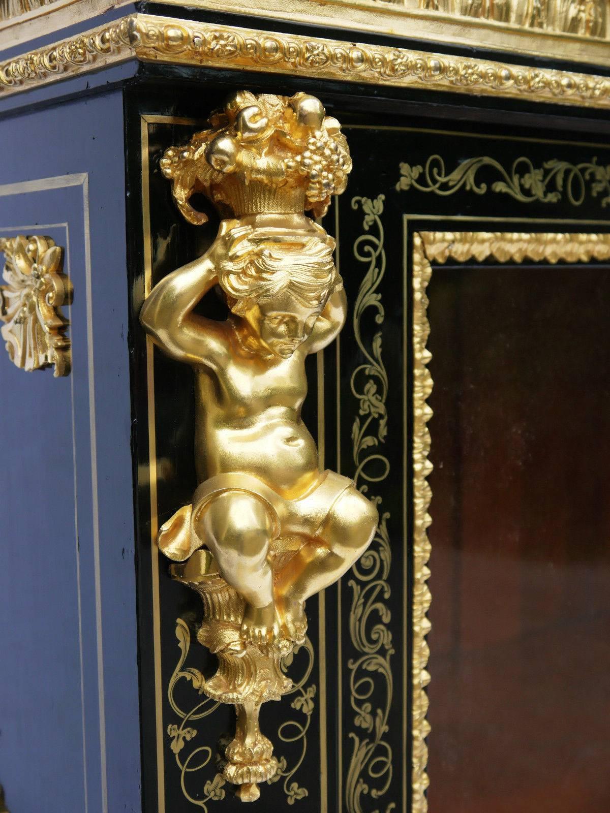 Exceptional Louis XIV style buffet lower cabinet with two glazed doors. Fine Boulle brass marquetry on the doors and on the front. Brass nets lined on the sides and on the base. Fabulous mercury gilded bronze of a quality and thickness typical of