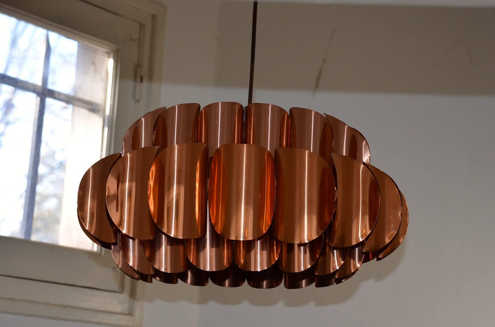 Circular ceiling pendant made of three tiers of round curved copper plates by Thorsten Orrling for Hans Agne Jakobsson AB Markaryd. This beautiful pendant gives a soft non-dazzle light sideways and a direct light downwards.