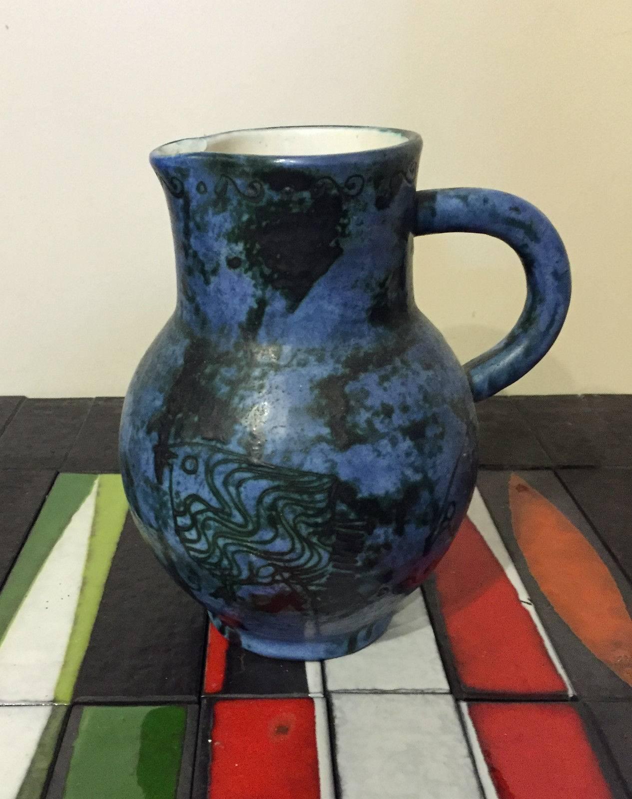 Gorgeous blue enamel ceramic pitcher and four glasses zoomorphic decor.
Mint conditions.

Pitcher dimension: 
Height: 20.5 cm.
Base: 8.5 cm.
Neck: 10 X 9 cm.

Glasses dimension:
Height:10.5 cm.
Base: 6 cm.
neck: 6.5 cm.

Free shipping.