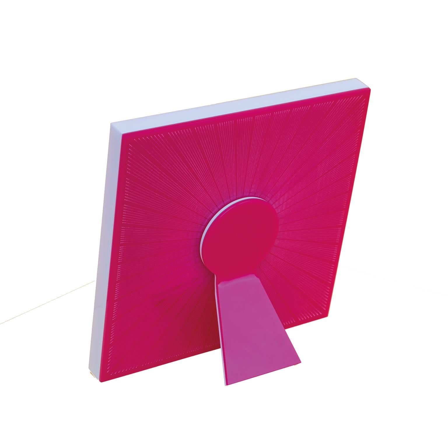 Sharing Shocking Pink  is a limited edition of Art with Heart collection of recto-verso photo frames by Laura G Italy. It is realized in shocking pink  and white artistic plexiglass , with guillochè rays hand worked into shocking pink flou plexi,