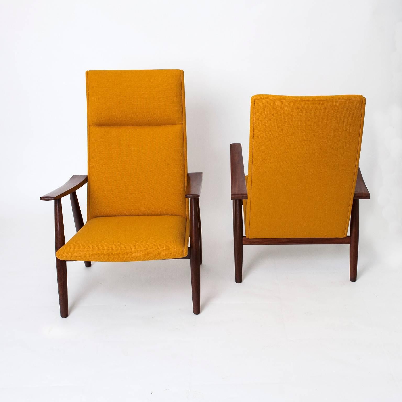 This is an original Hans Wegner designed GE 260A high back lounge chair, produced by Getama, Denmark. Made from a solid teak frame and upholstered in Midas fabric. The 260A lounge chairs differ from some of the more common Wegner designed chairs as
