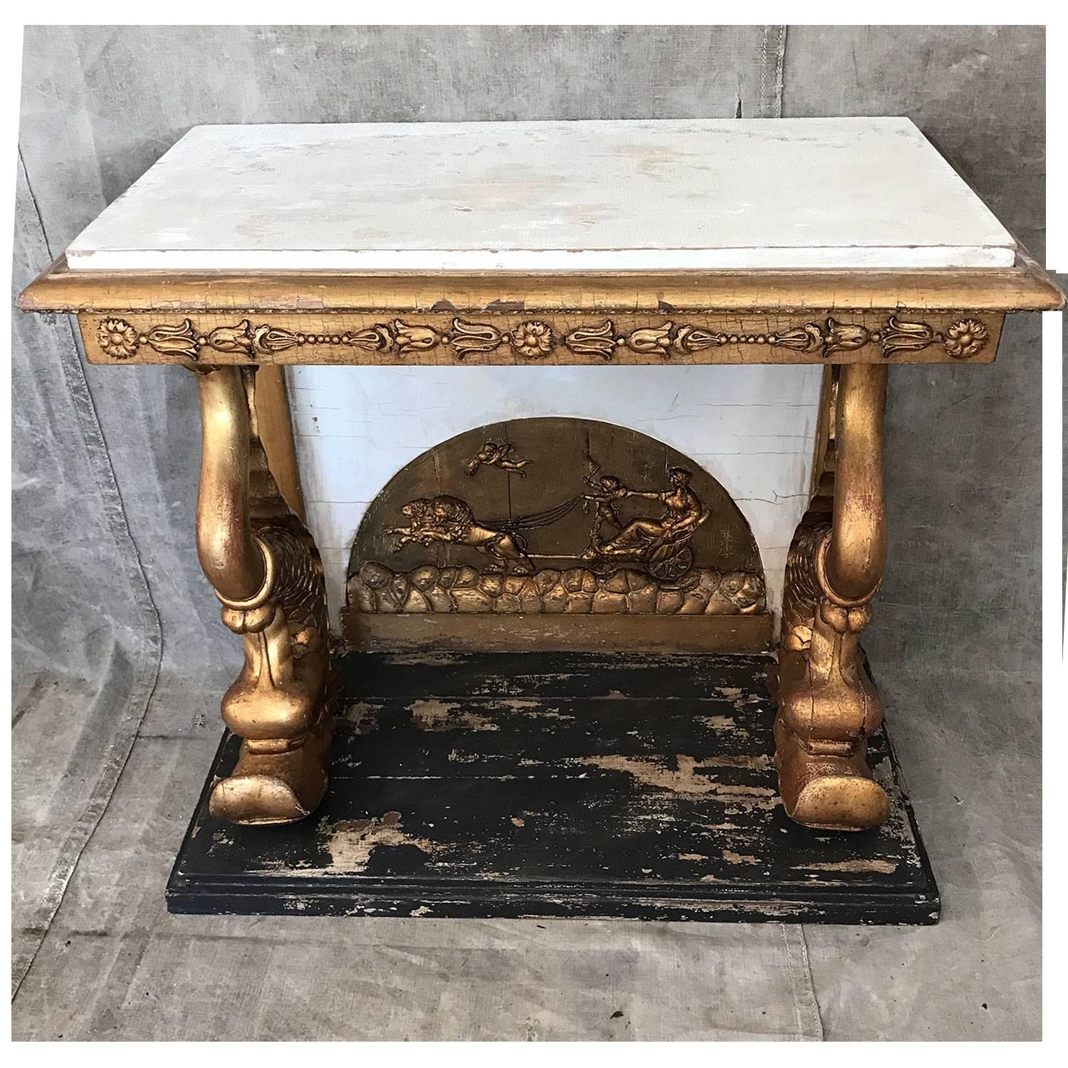 19th century Swedish empire console table. Two fully carved dolphins supports the wooden tabletop on a black wooden base. Classic details like lions, cupids and flower ornaments.