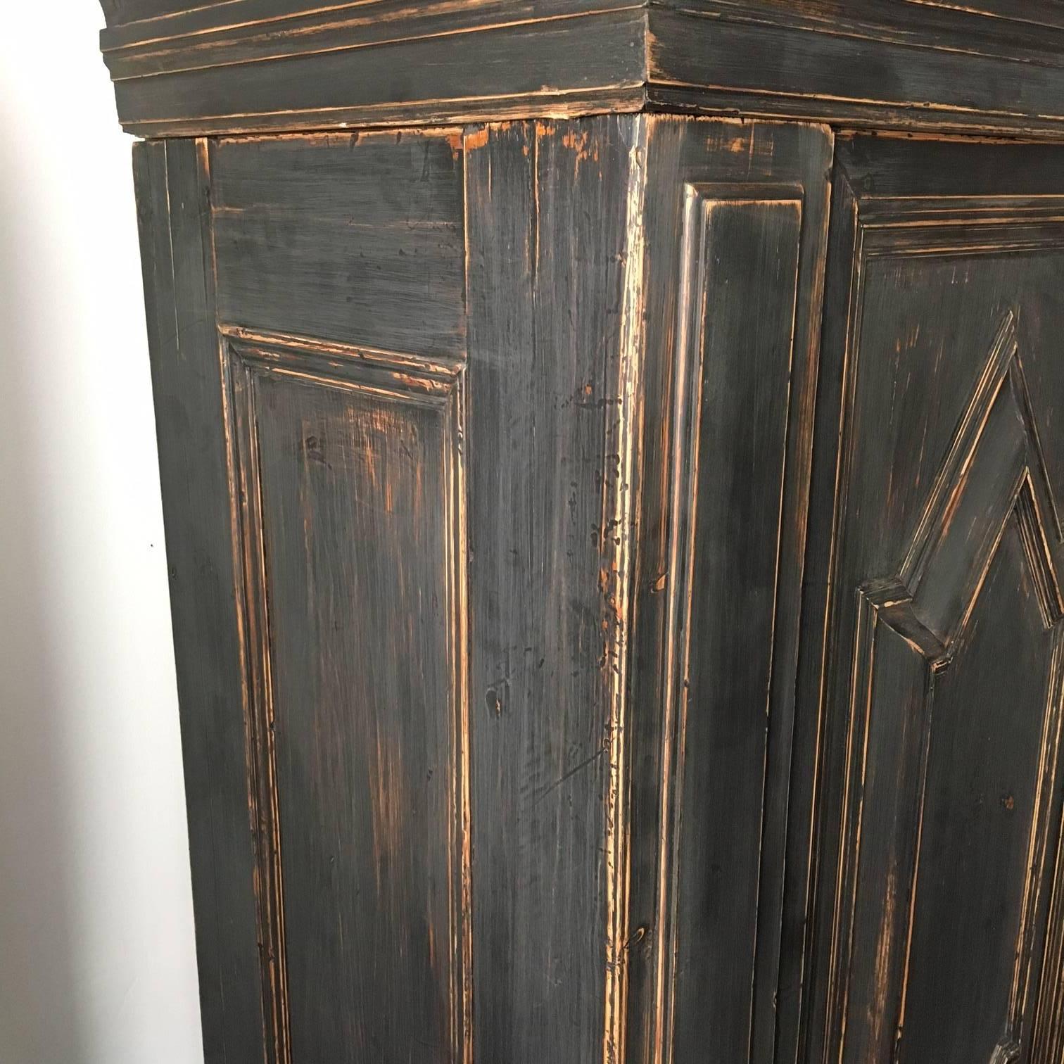 18th century Swedish barouqe cabinet, later black painting, original lock and key. Shelfs and drawers behind doors, spoon shelf. Two drawers at the bottom. Total 11 pieces. 193 cm wide.