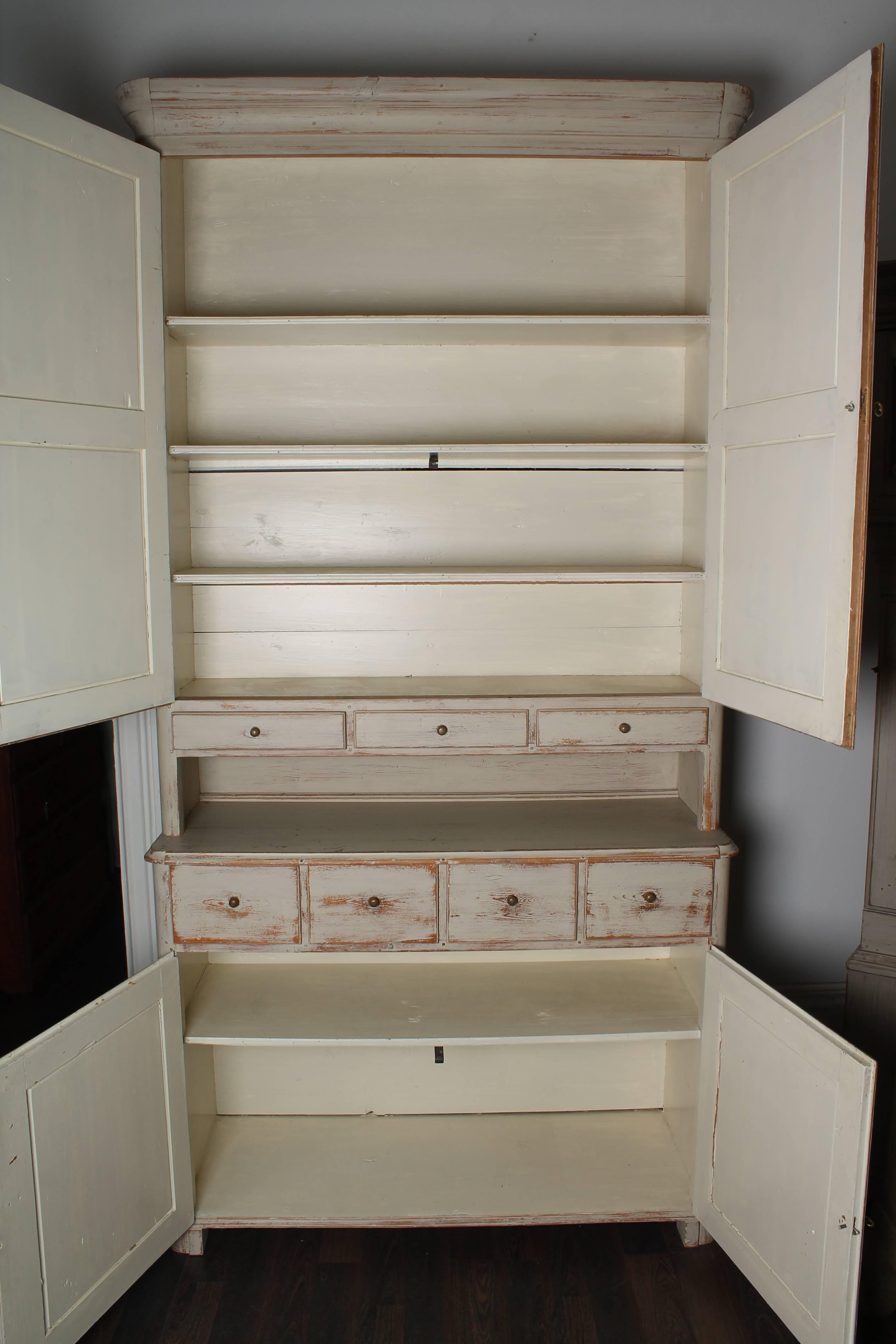 19th century Swedish cabinet. Two parts. Two doors and three drawers at the top and two doors and four drawers. White/grey painting.

Perfect as kitchen cabinet!