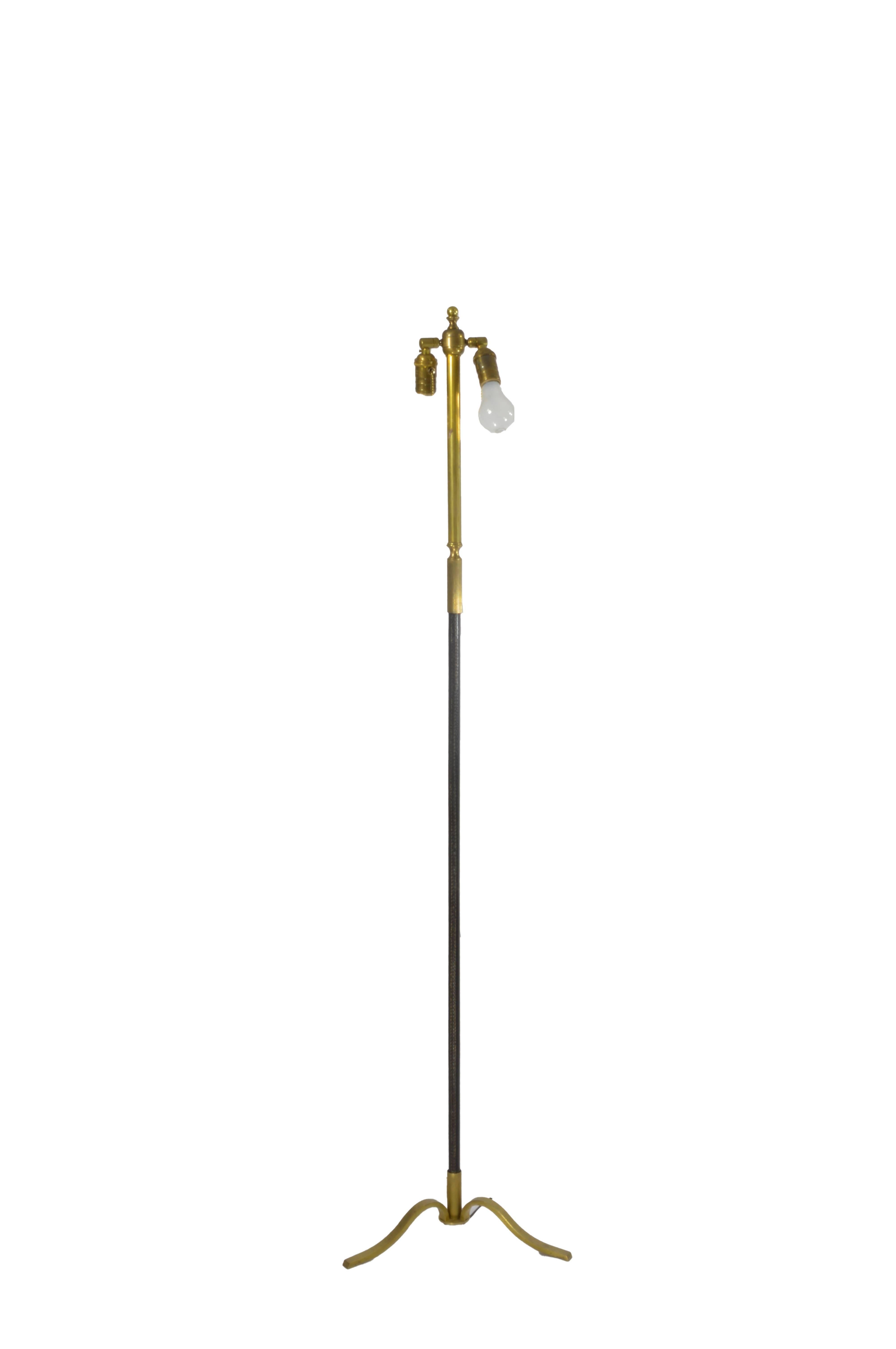 Sleek black leather and brass floor lamp with tripod base. Lamp shade included.