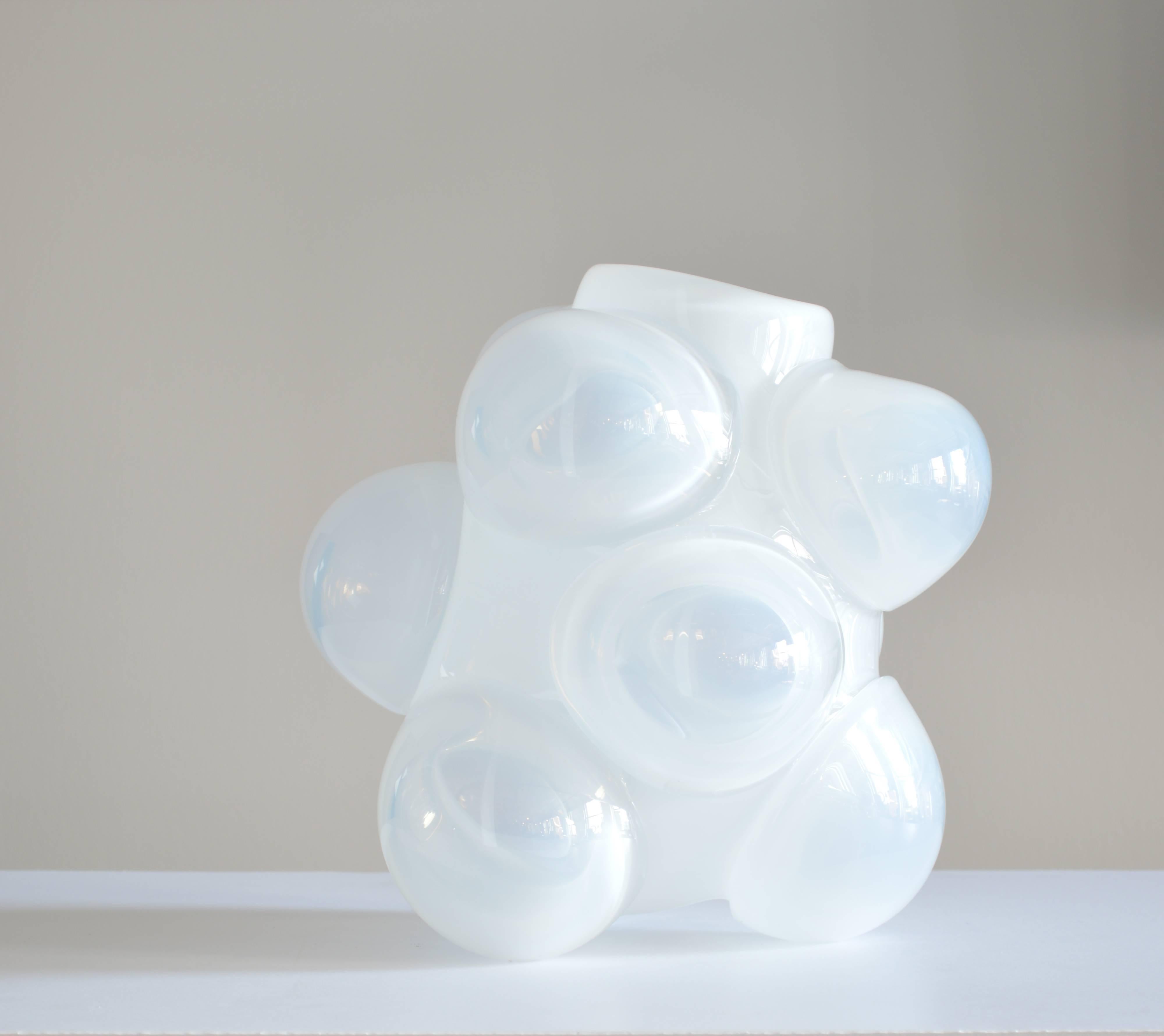 Handblown lead free crystal vase features a central core, with blown glass bubbles, creating a cloud-like shape. The vase made by glassblowers Caleb Siemon and Carmen Salazar in California.