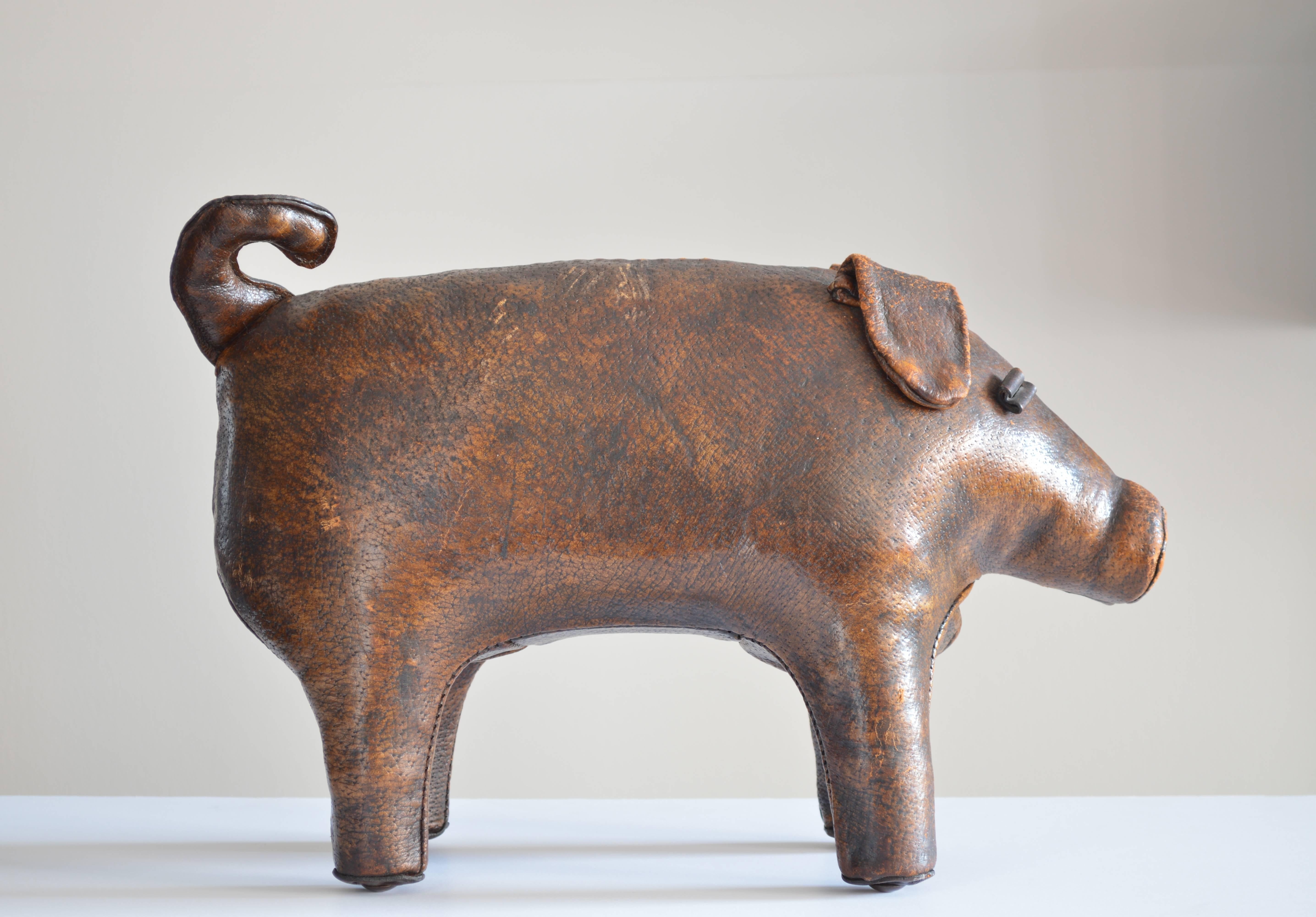 This leather pig makes a great footstool or decorative object. The leather of this piece has a beautiful patina to it that lends a rich finish to the piece.