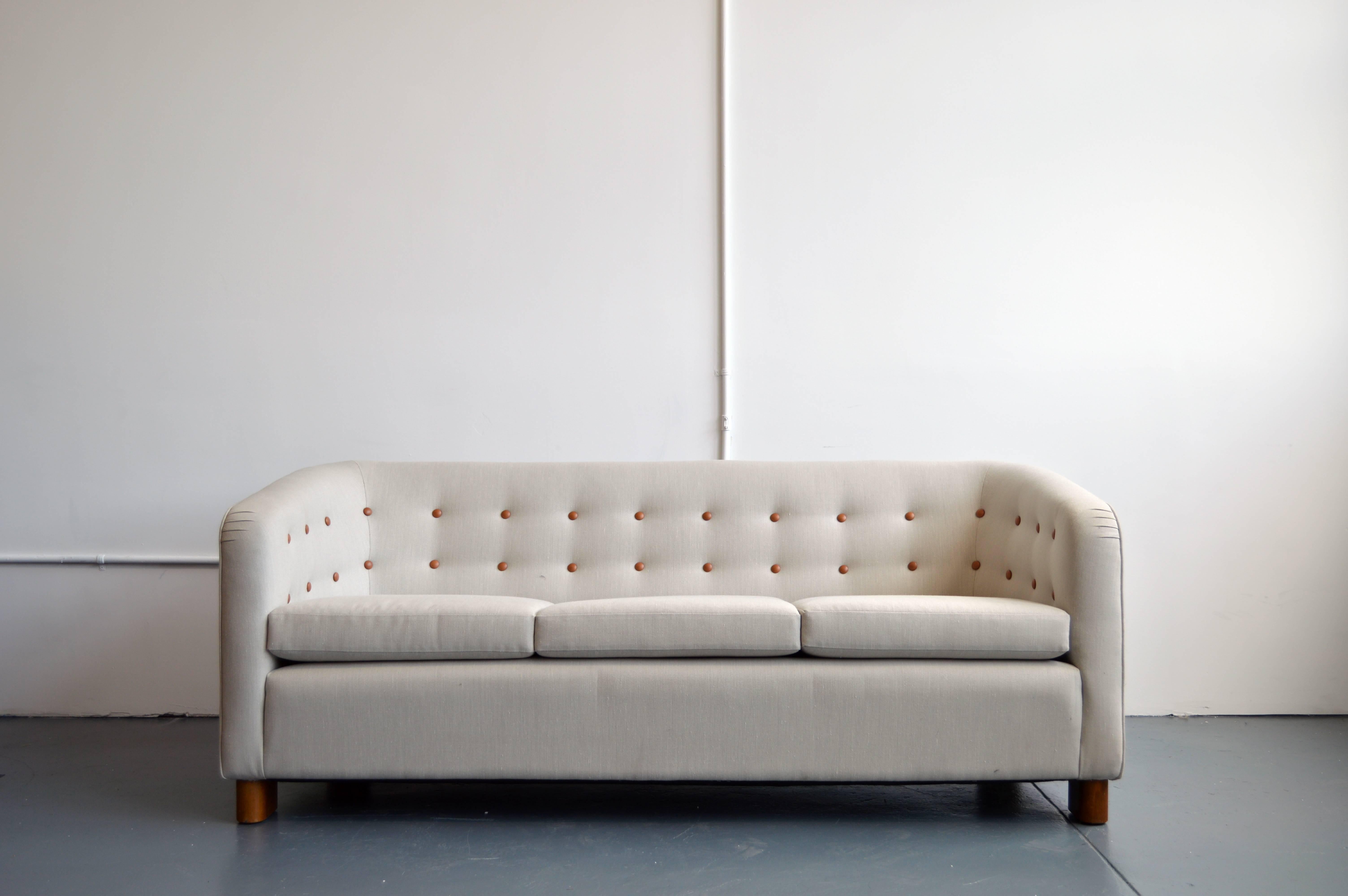 This Mid-Century Modern model 1668 three-seat sofa was designed by Ole Wanscher for Fritz Hansen, circa 1942.