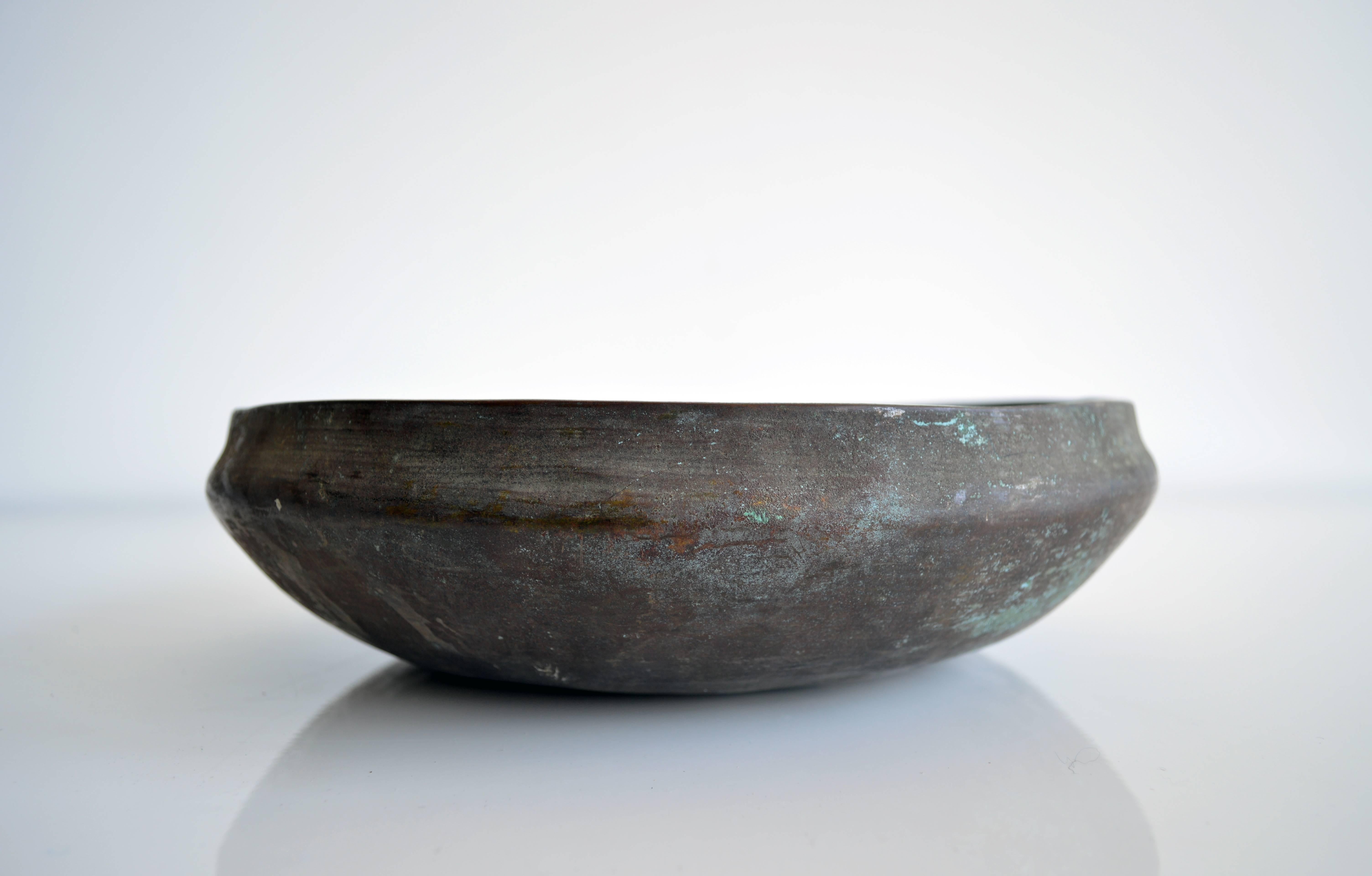 Large brass bowl with beautiful patina makes for a perfect centerpiece or decorative object.