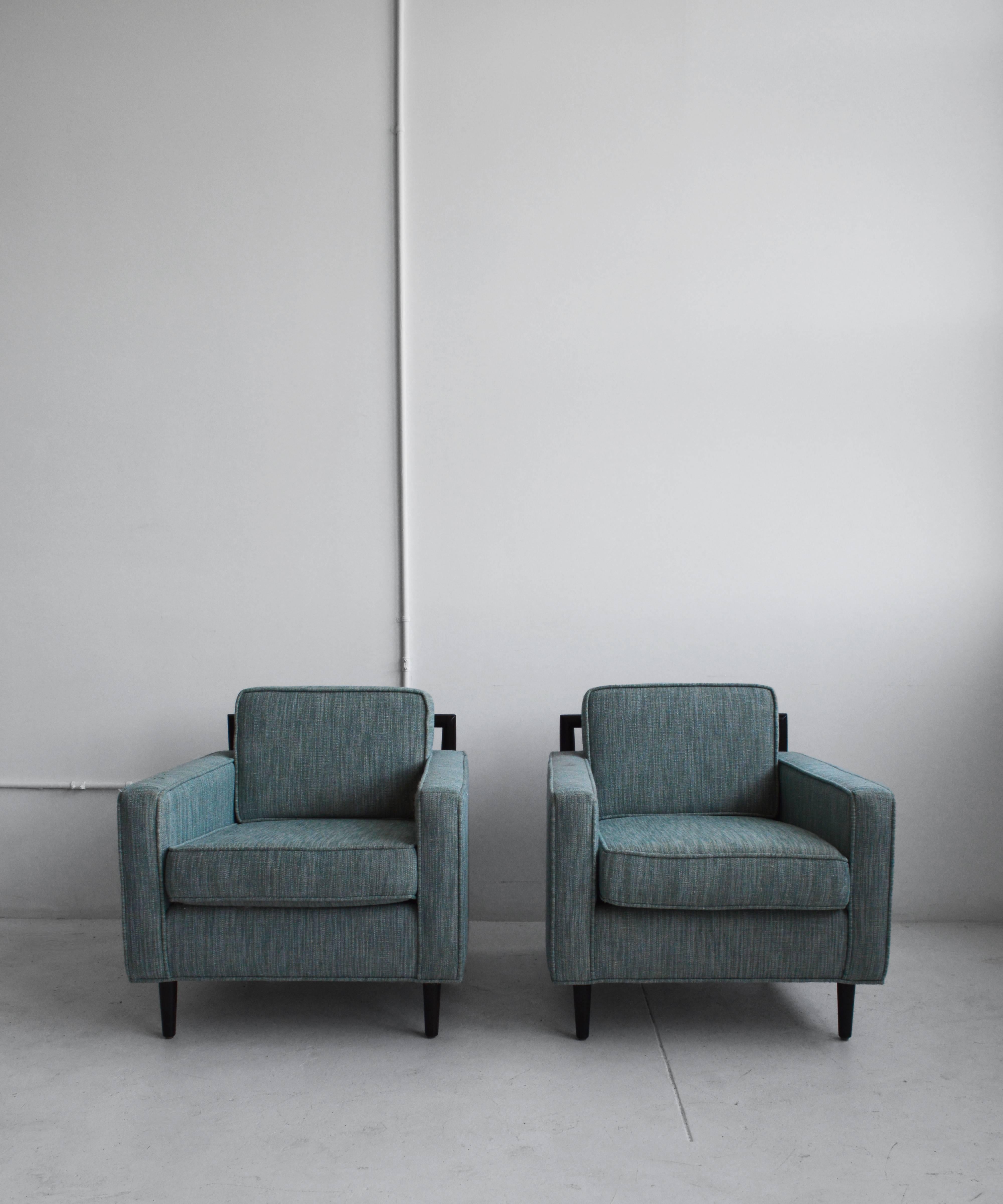 Pair of chic, Mid-Century inspired lounge chairs designed by Michele Sommerlath and produced in LA by Atelier Sommerlath. The pair of chairs have solid walnut backrests and are upholstered in a textured, blue upholstery. These chairs would make a