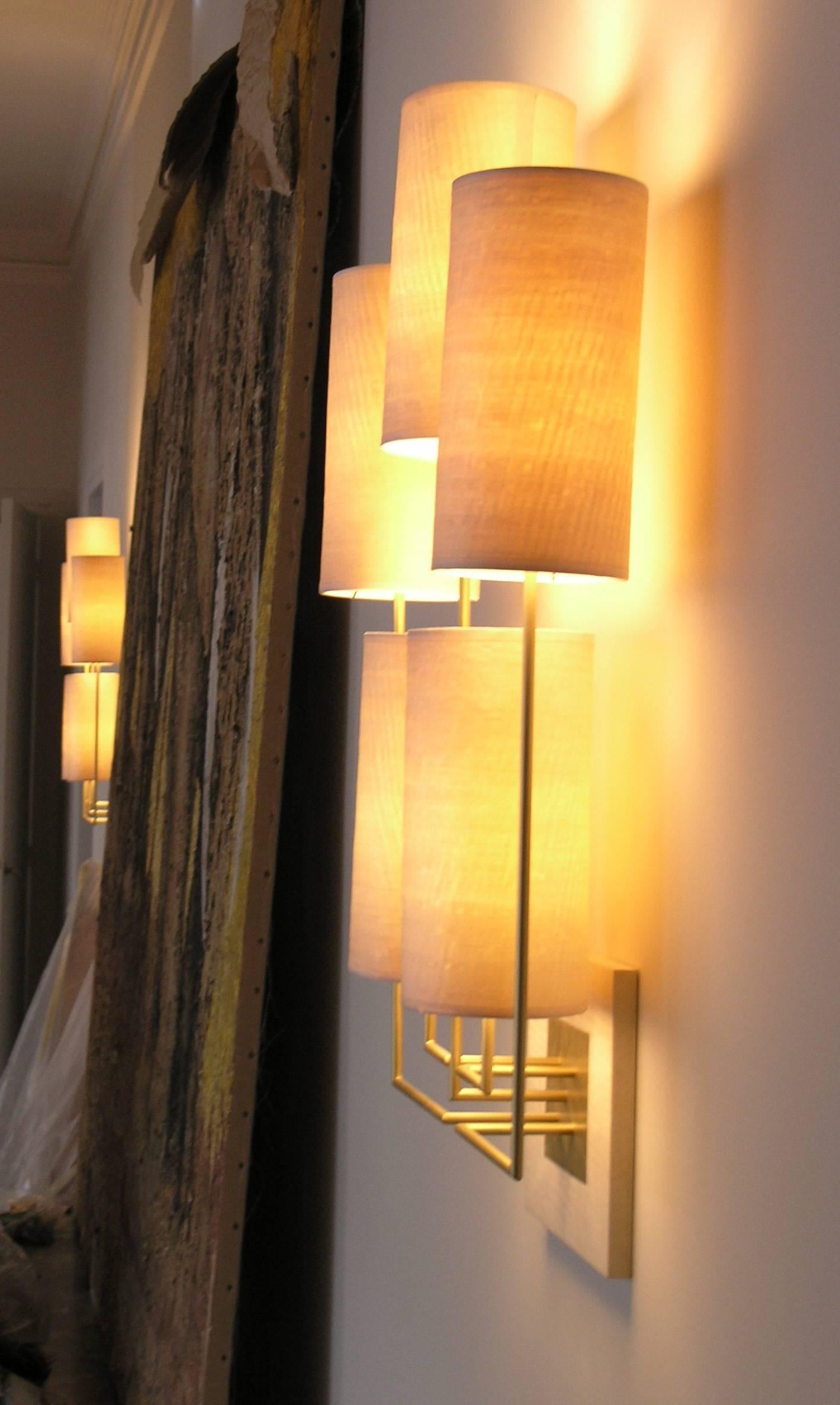 Wall Lamp Sconce “Tige5” Gold Bronze Patina and Five Wooden lampshades by Aymeric Lefort made to order. 
This wall lamp is made in a metal gold patina tube fixed on a wooden Sycomore scare. The lampshade is made in 