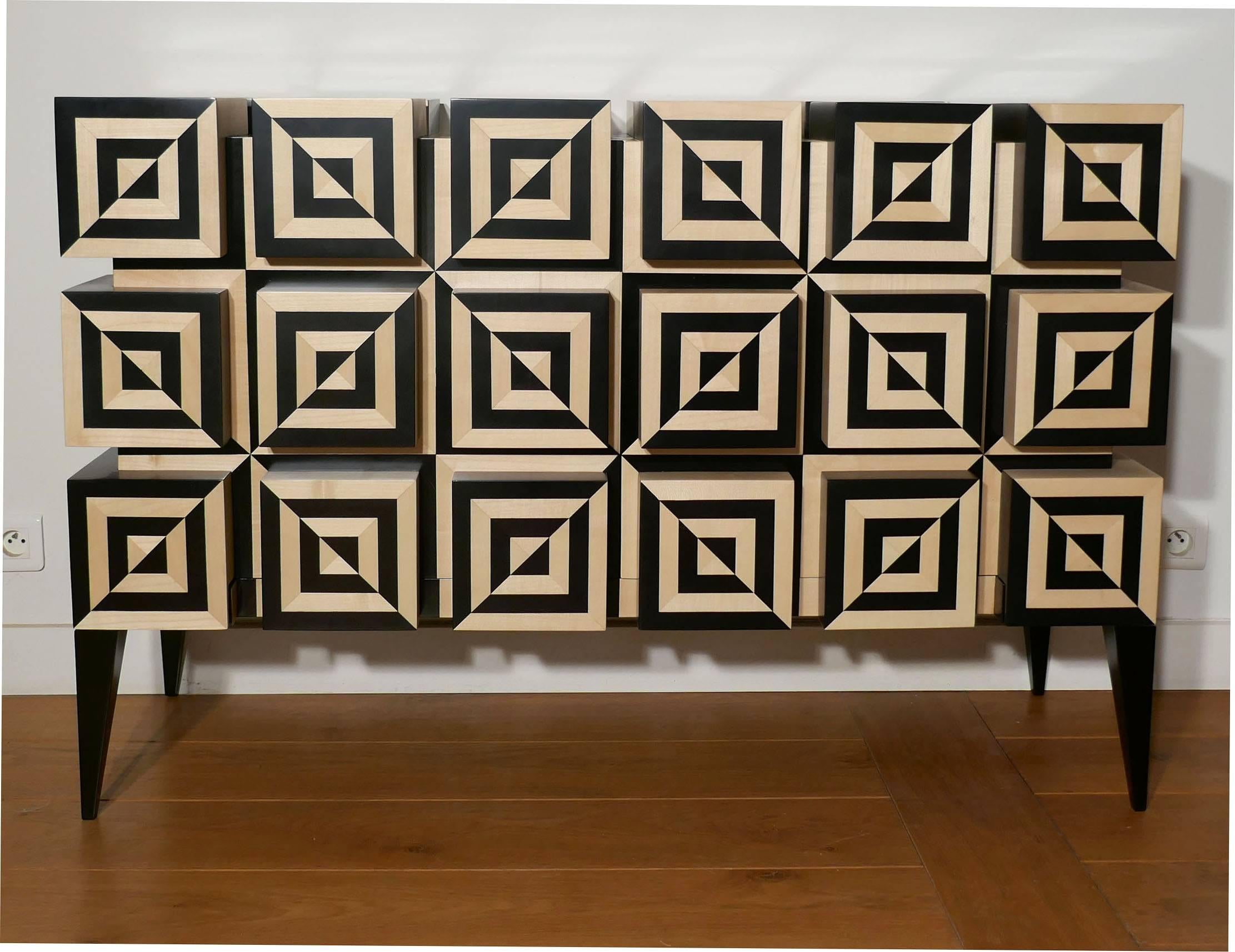 “Ondulation 2” is an association of 42 squares, Black tinted sycamore and White sycamore marquetry to create a Kinetic distortion. More than 700 pieces are needed to build this marquetery.
The buffet opens in two doors to reveal one shelf in the