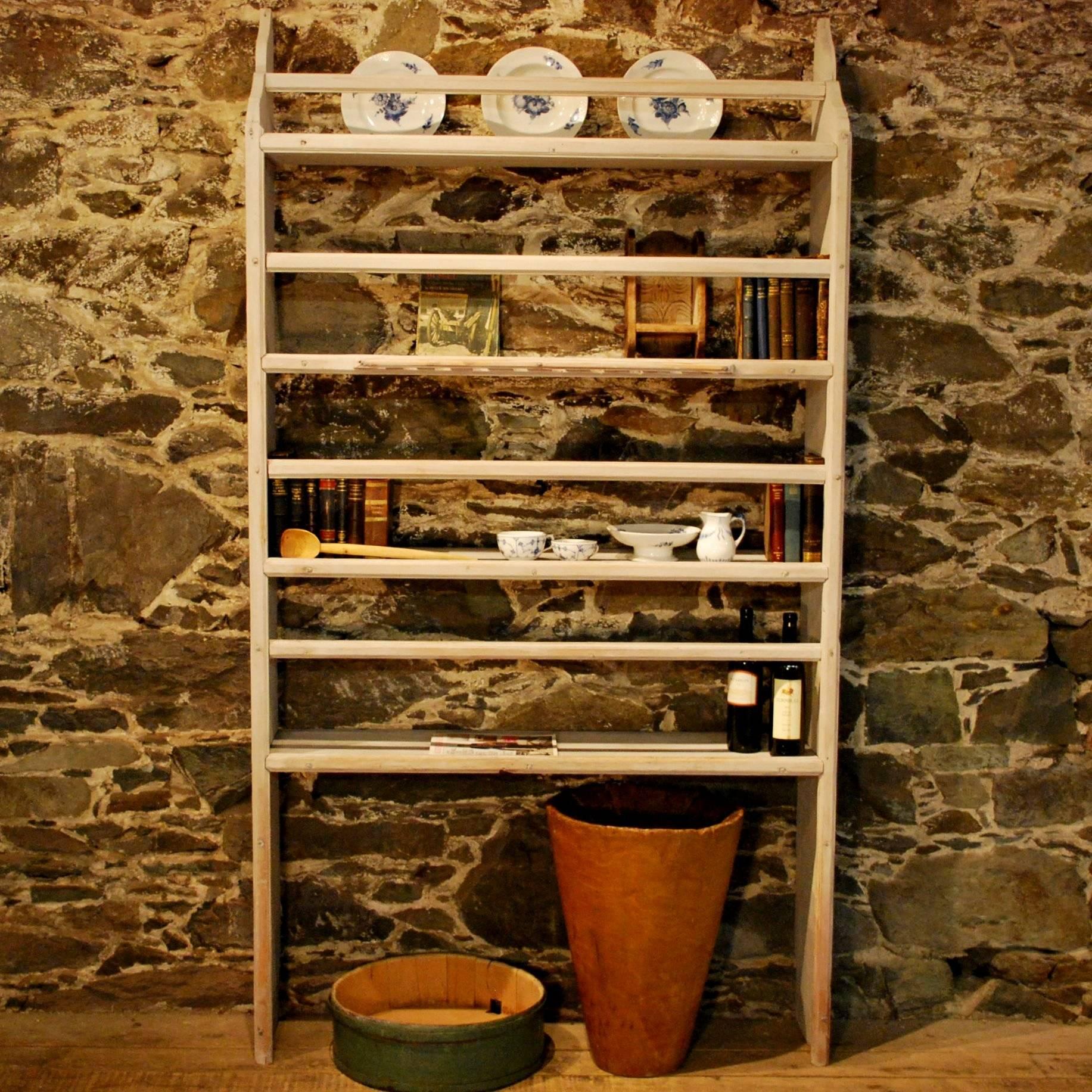 A rare antique pine open kitchen shelf, very well crafted and displaying a spoon shelf, unusual large size and warm color and patina of age. With later Gustavian influenced paintwork.