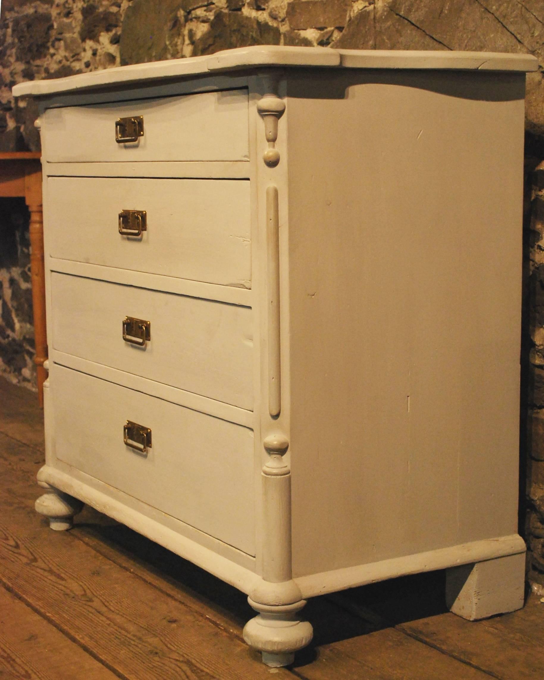 Antique Danish four-drawer chest with decorated cantered corners, single board drawer fronts, and a shaped top. The Gustavian style paint and brass hardware makes it a perfect piece for any room.