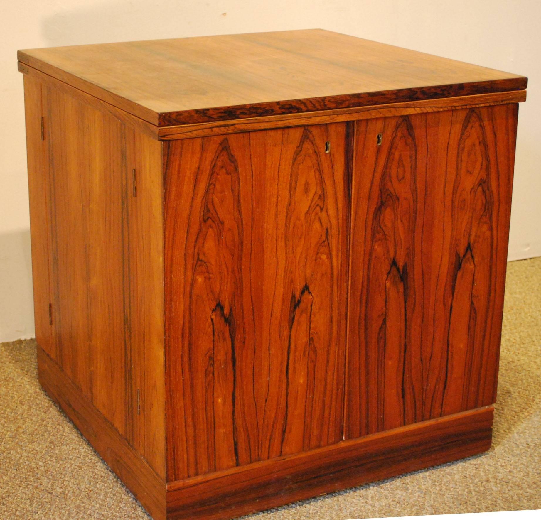 Rare rosewood bar cube on wheels. This piece upgrades the usual drinks cart by having both sides lock and open independently. Very high quality piece where you can discreetly secure your 'private stock' within reach. Storage for assortment of