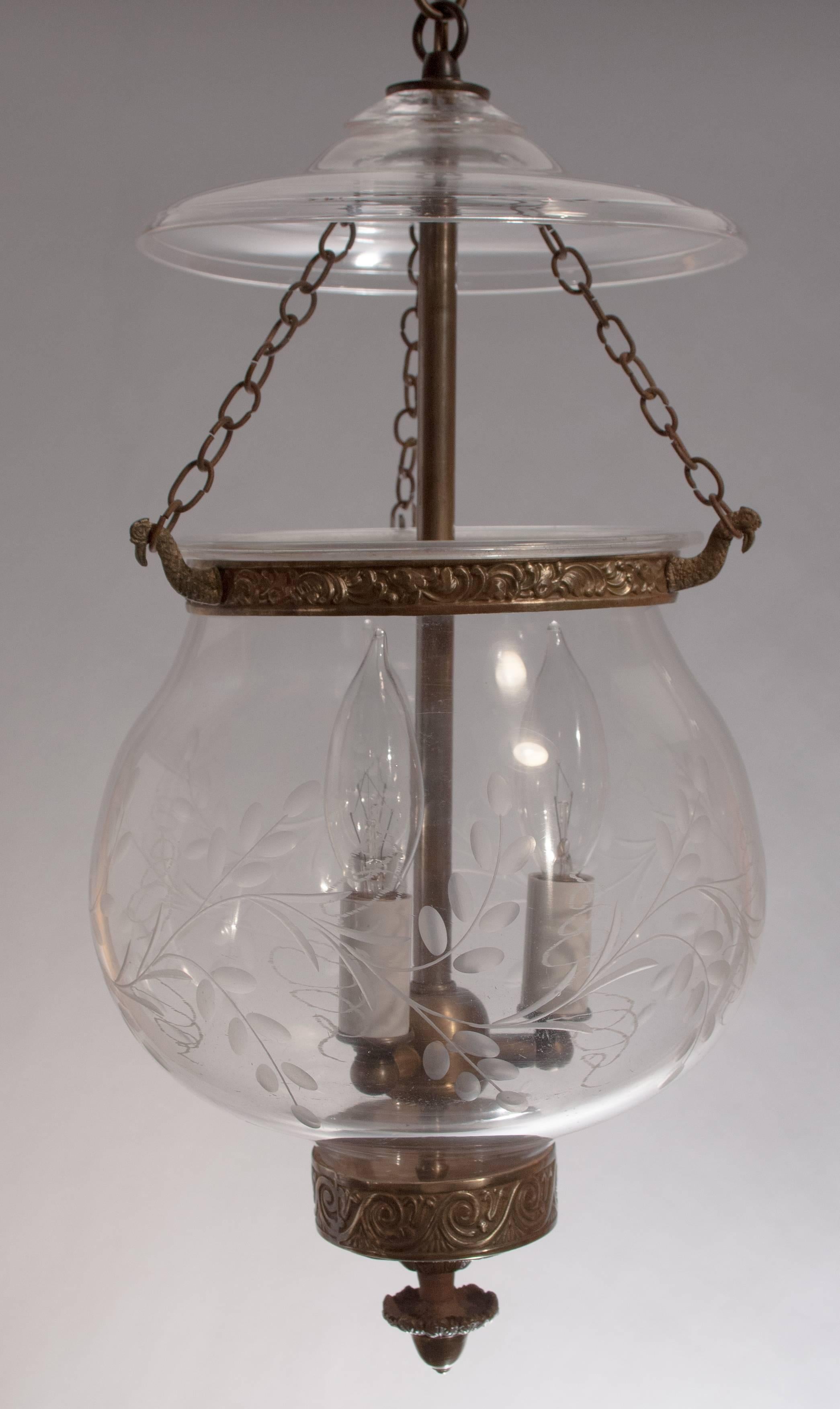 Handblown English globe bell jar lantern, circa 1850, with lovely form and finely etched vine design. This antique hall lantern has its original smoke bell, decorative brass candle holder and band. The pendant light has been newly electrified with a