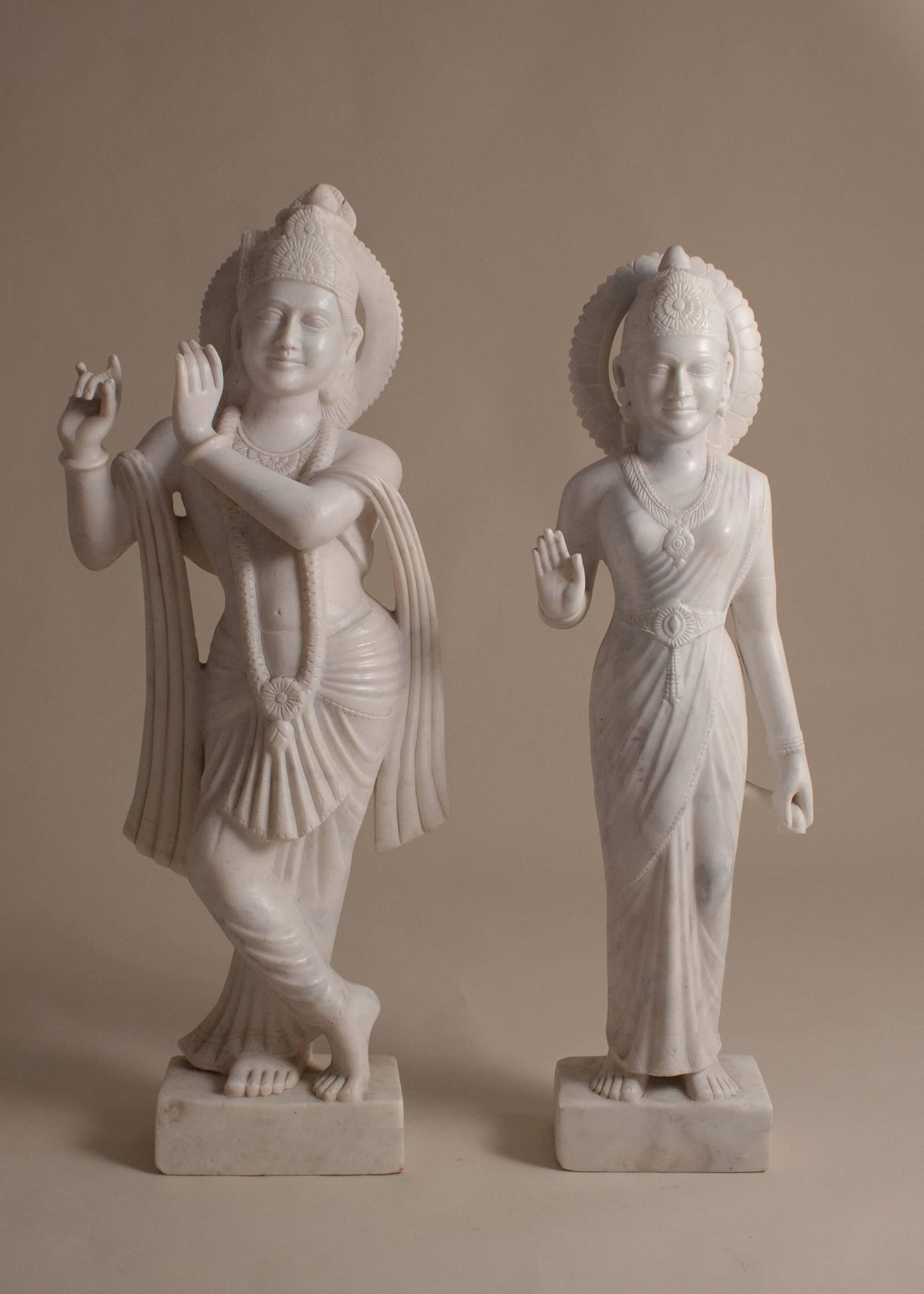 Hand carved from white marble, Supreme Goddess Radha enchants Krishna as he plays his flute. Standing at approximately three feet tall, these eternal lovers will grace any landscape or interior space that they inhabit. Circa 1970. 