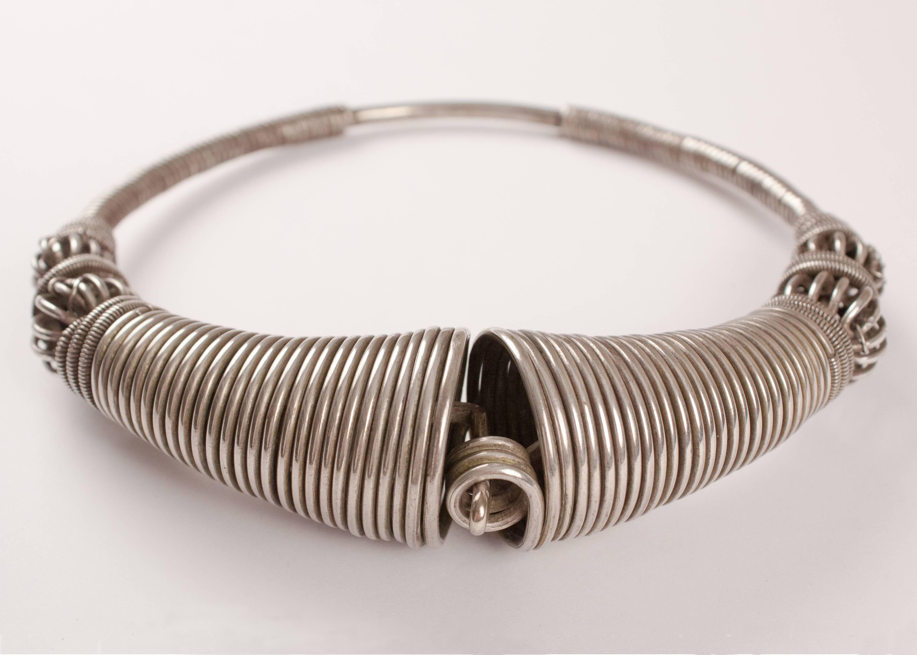 Traditional torque or Hansuli silver necklace from Gujarat in Northwest India, circa 1940. This sculptural and coiled choker looks truly amazing on any neck or collar. Measurements: 6.50 x 6.75 (outside diameter); 5.75 x 5 (inside diameter); 1.38