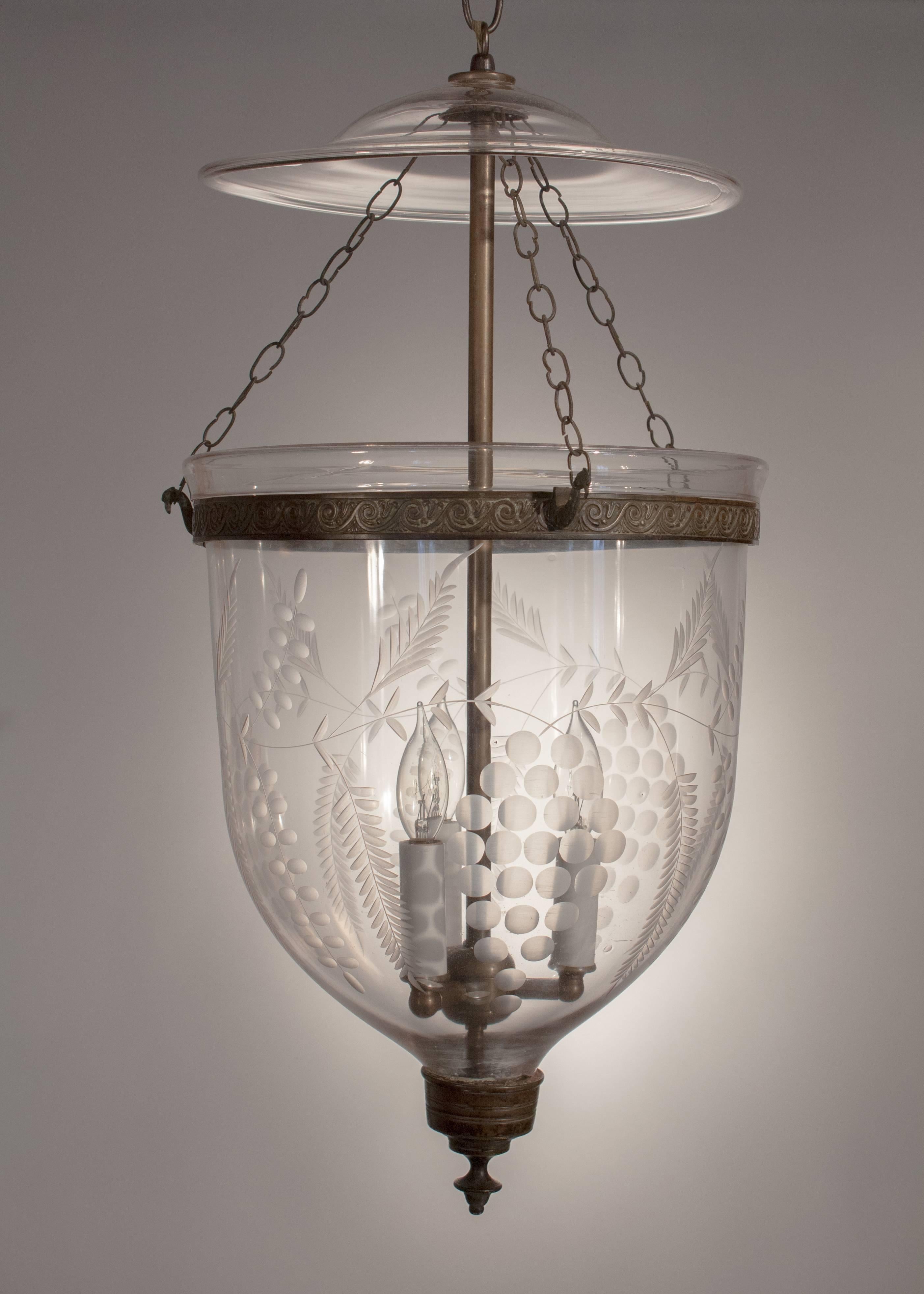 Classic English handblown glass bell jar lantern, circa 1850, with a grape and vine etched design that complements the shape of this large lantern beautifully. The hall lantern, which is in excellent condition, has its original glass smoke bell,