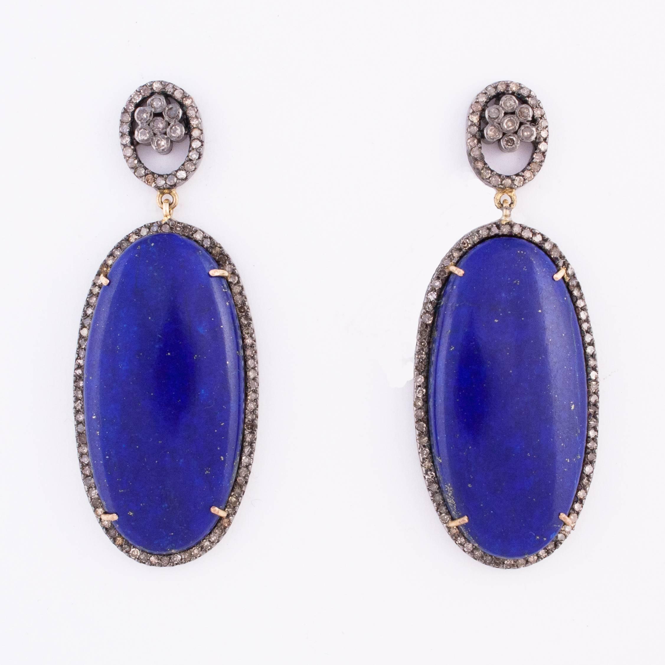 Beautiful cabochon lapis lazuli drop earrings edged with rose cut diamonds set in sterling silver. The earring studs are diamond ovals inset with diamond flowers. Oval shaped lapis measures 1.50