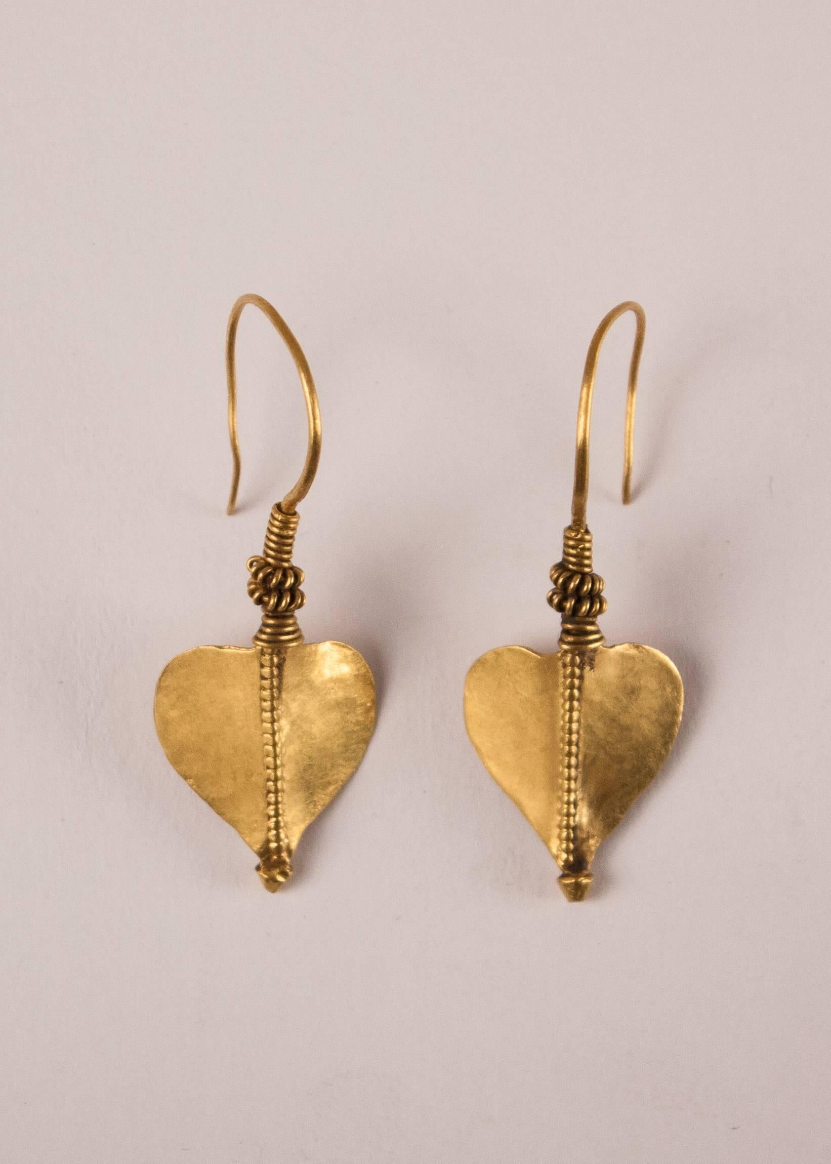 A collector's pair of traditional 22-karat gold earrings, circa 1930 from Rajasthan, India. These lovely dangle earrings have a hand tooled leaf design that is inspired by the venerated peepal tree. Weight is 3.6 grams per earring. Measurements: