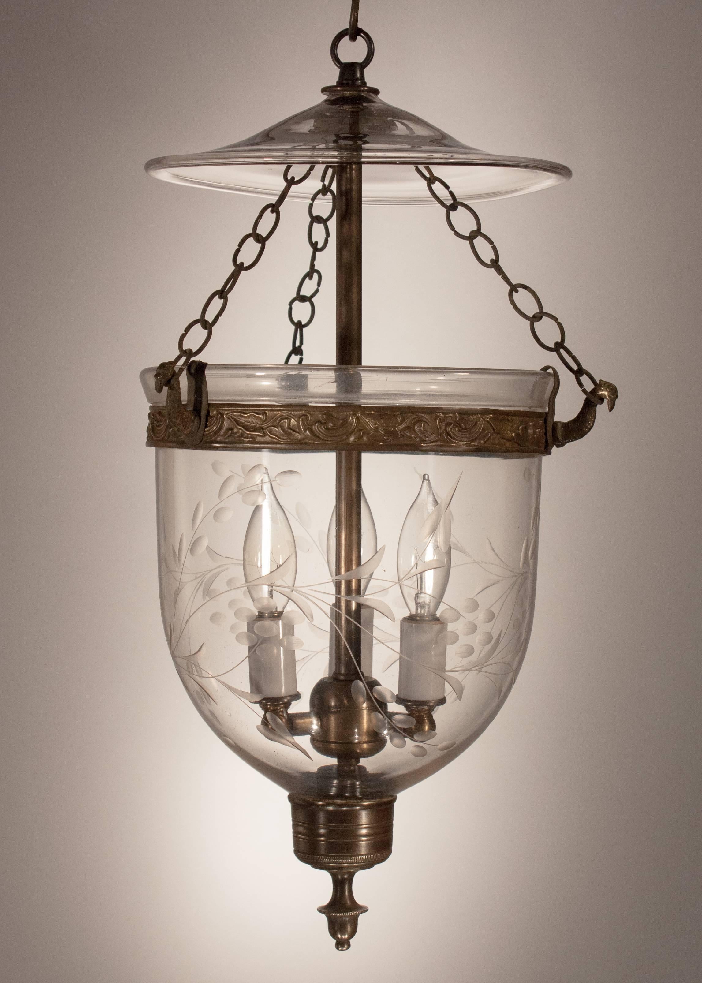 A smaller-sized English bell jar lantern, circa 1870, with a meandering etched vine design that suits this charming hall lantern beautifully. The quality of the hand blown glass is of outstanding and the bell jar makes a clear tone when