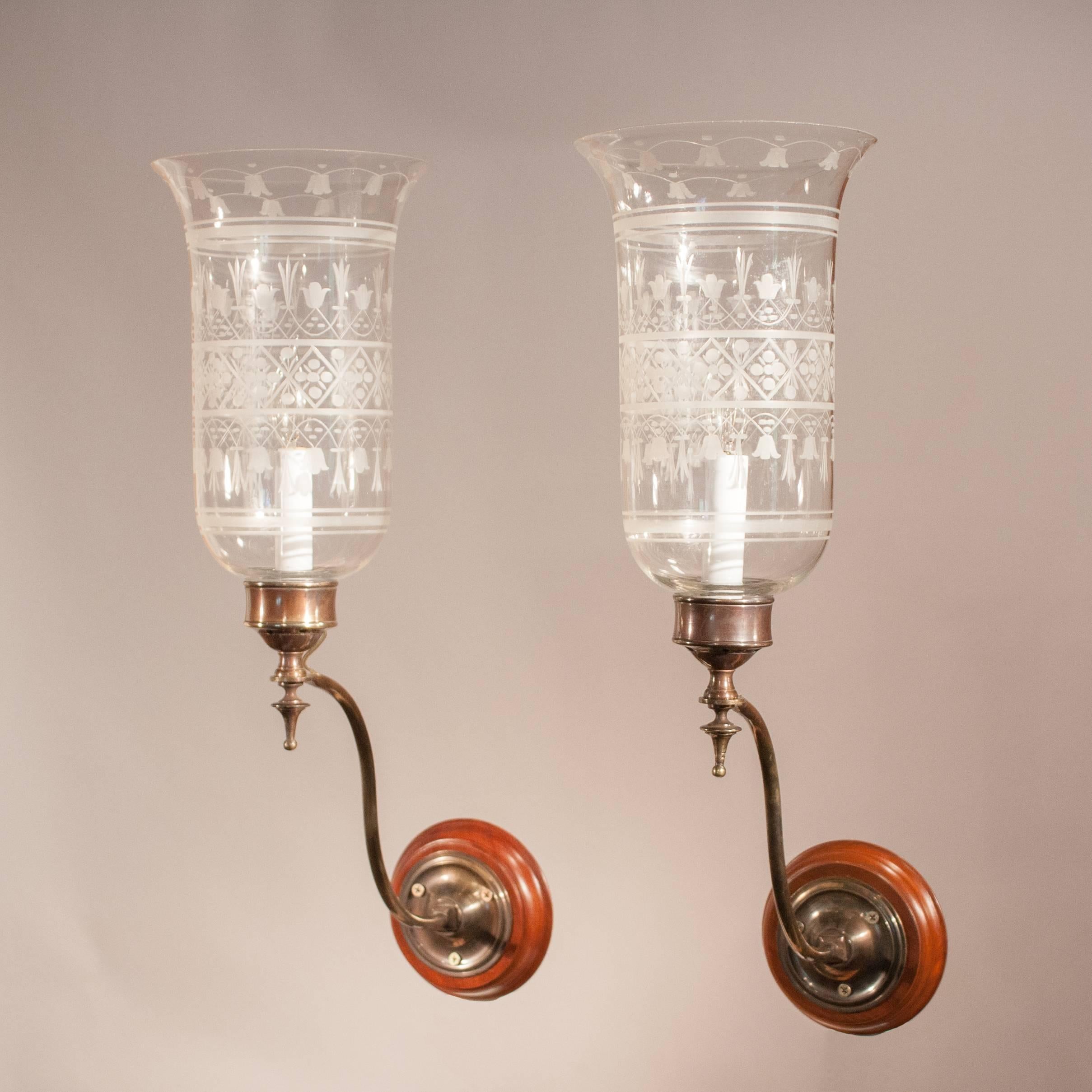 Lovely pair of antique English handblown glass hurricane sconce shades with a graceful flair at top and full-form, acid etched floral design. Originally for candles, these 1920s wall sconces are newly electrified and take a single candelabra bulb