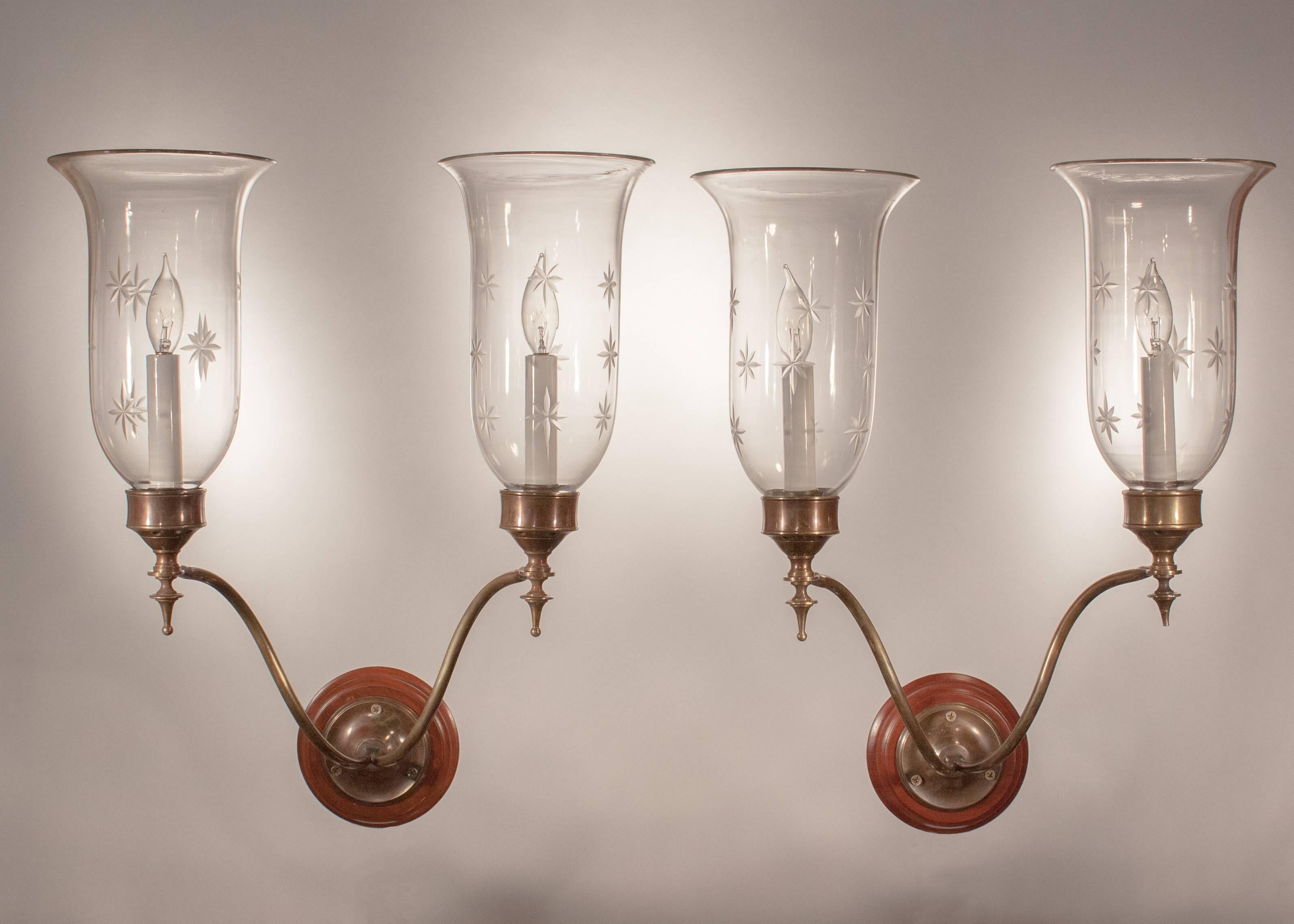 Set of four well-matched, gracefully flared English hurricane sconce shades, circa 1890, featuring superb quality handblown glass and etched stars. The sconces have been newly electrified, with each shade casting a lovely light from a single