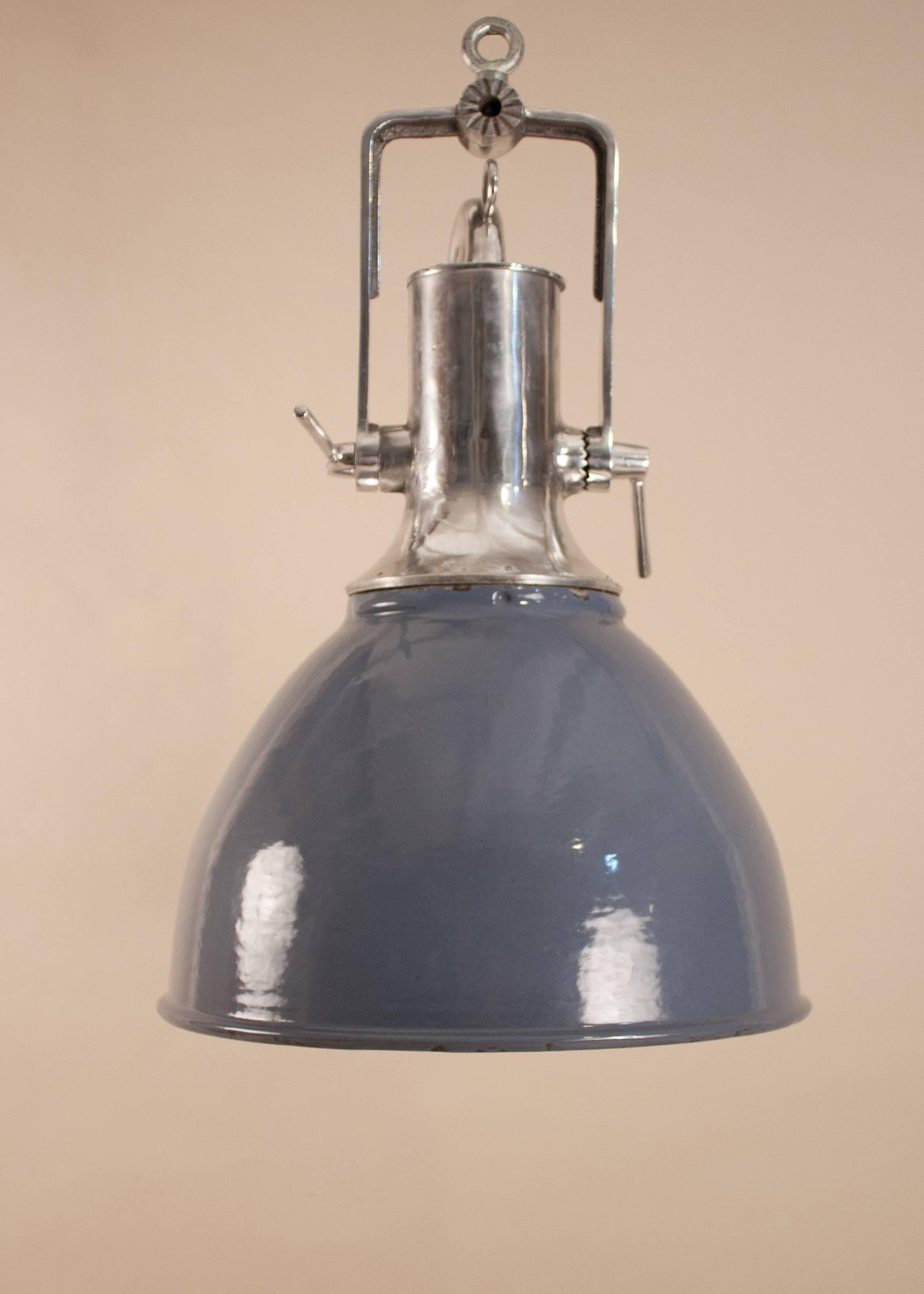 Good-looking large Industrial floodlight in an attractive combination of warm gray enamel and aluminum. The domed shade, which was salvaged from a maritime vessel, has minor blemishes on the gray enamel and white interior that enhance the